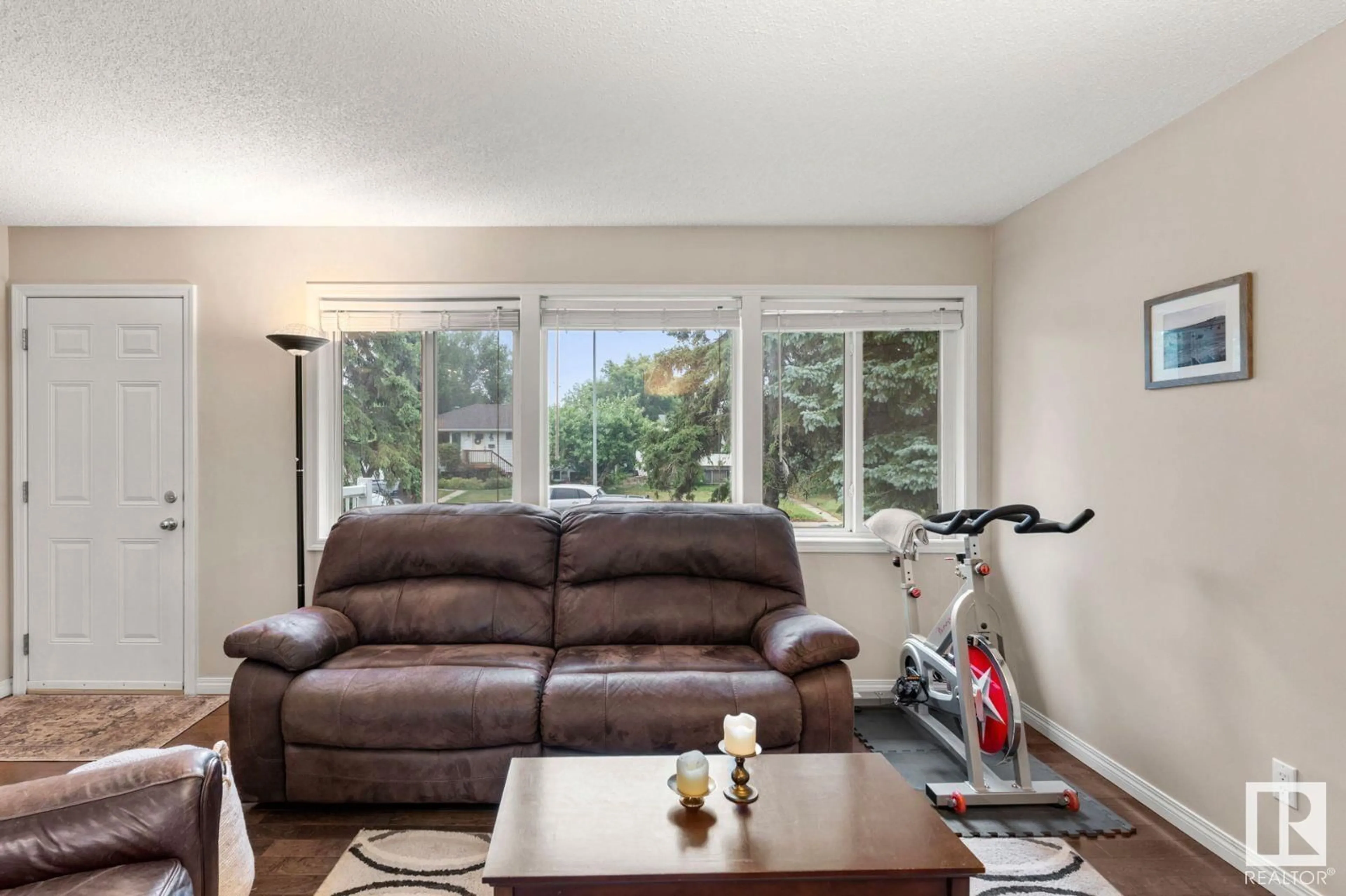 Living room with furniture, wood/laminate floor for 11022 157 ST NW, Edmonton Alberta T5P2W5