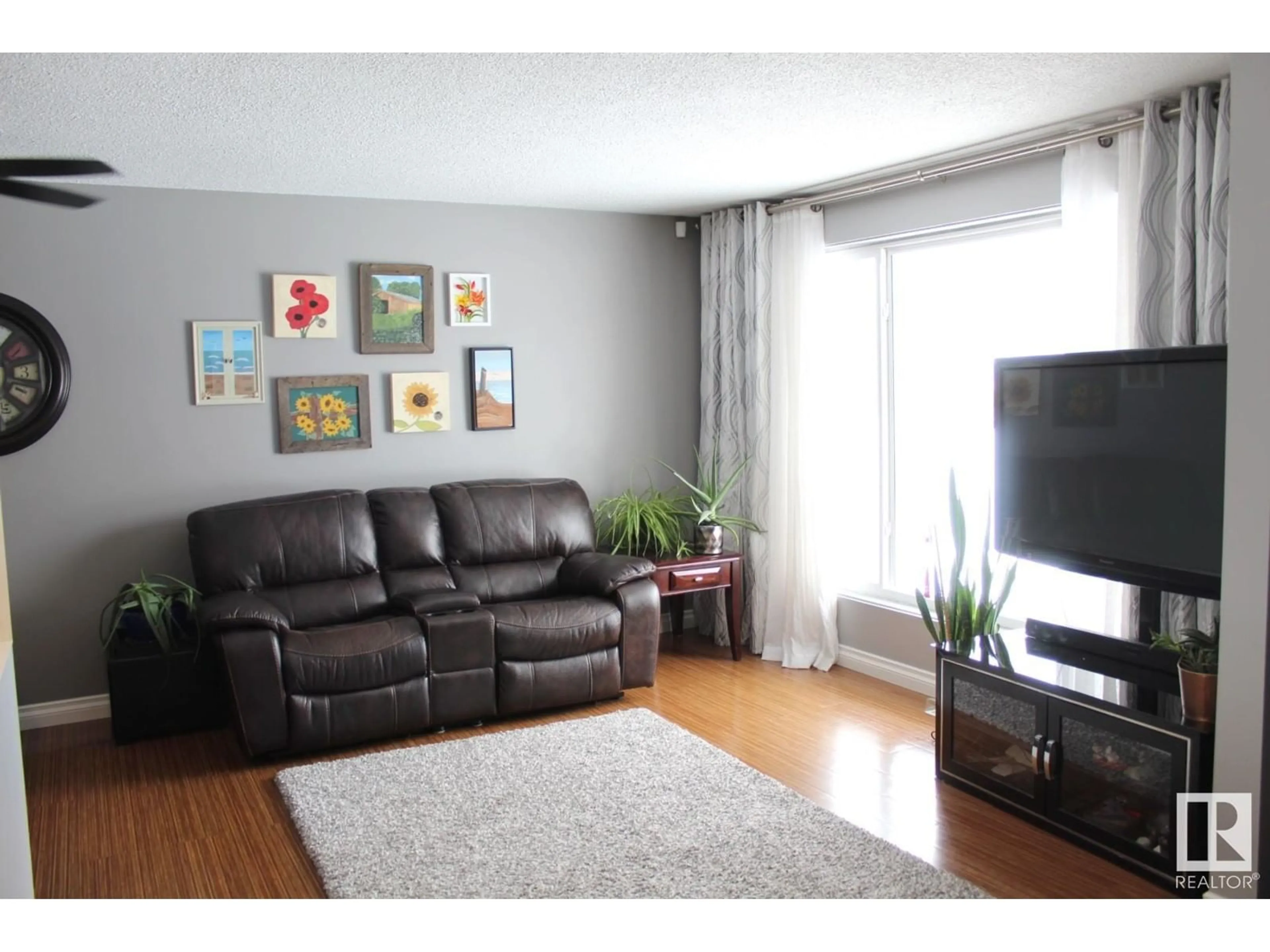 Living room with furniture, wood/laminate floor for 16723 81 AV NW, Edmonton Alberta T5R3P8