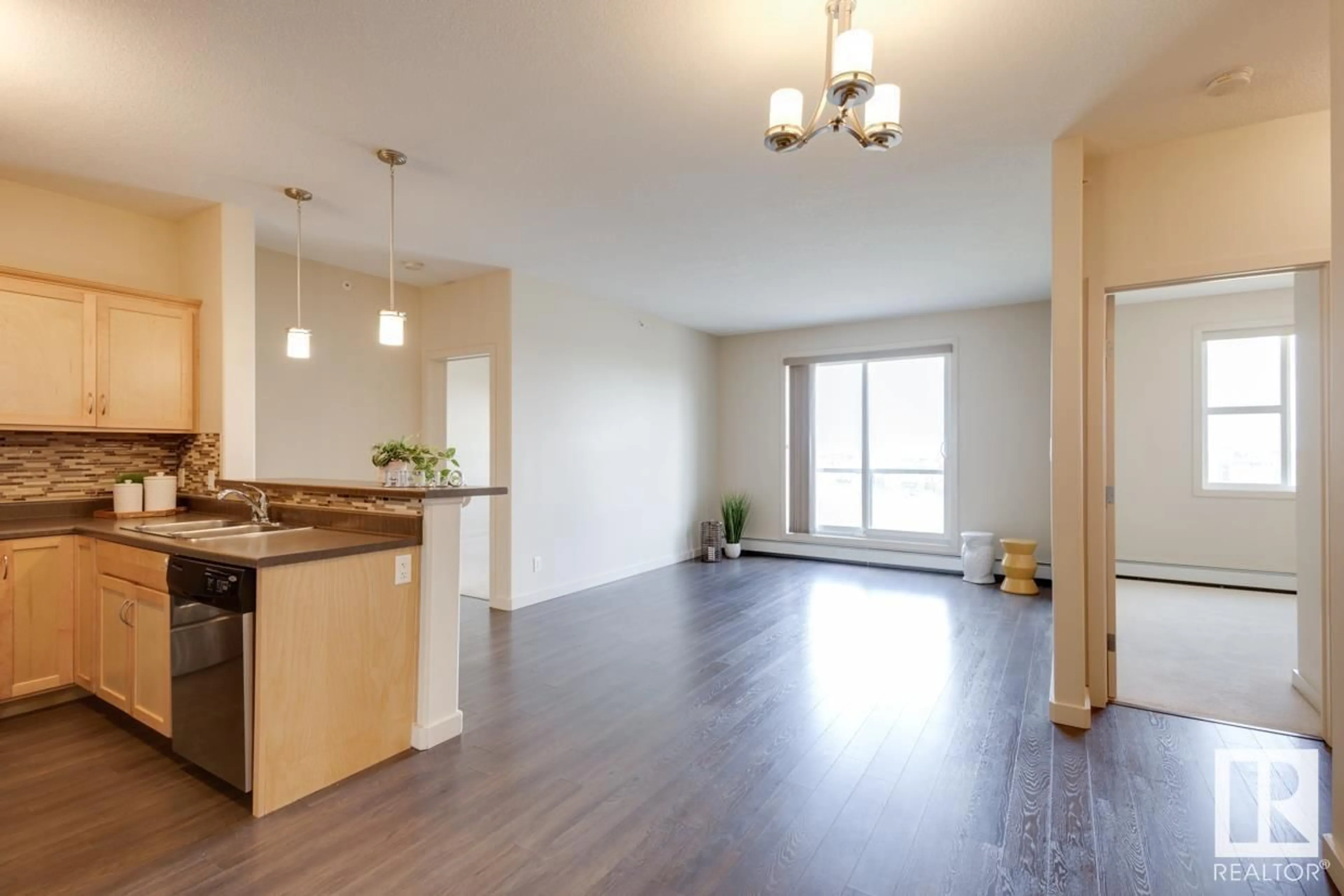 Open concept kitchen, wood/laminate floor for 412 - 304 AMBLESIDE LI SW, Edmonton Alberta T6W0V2