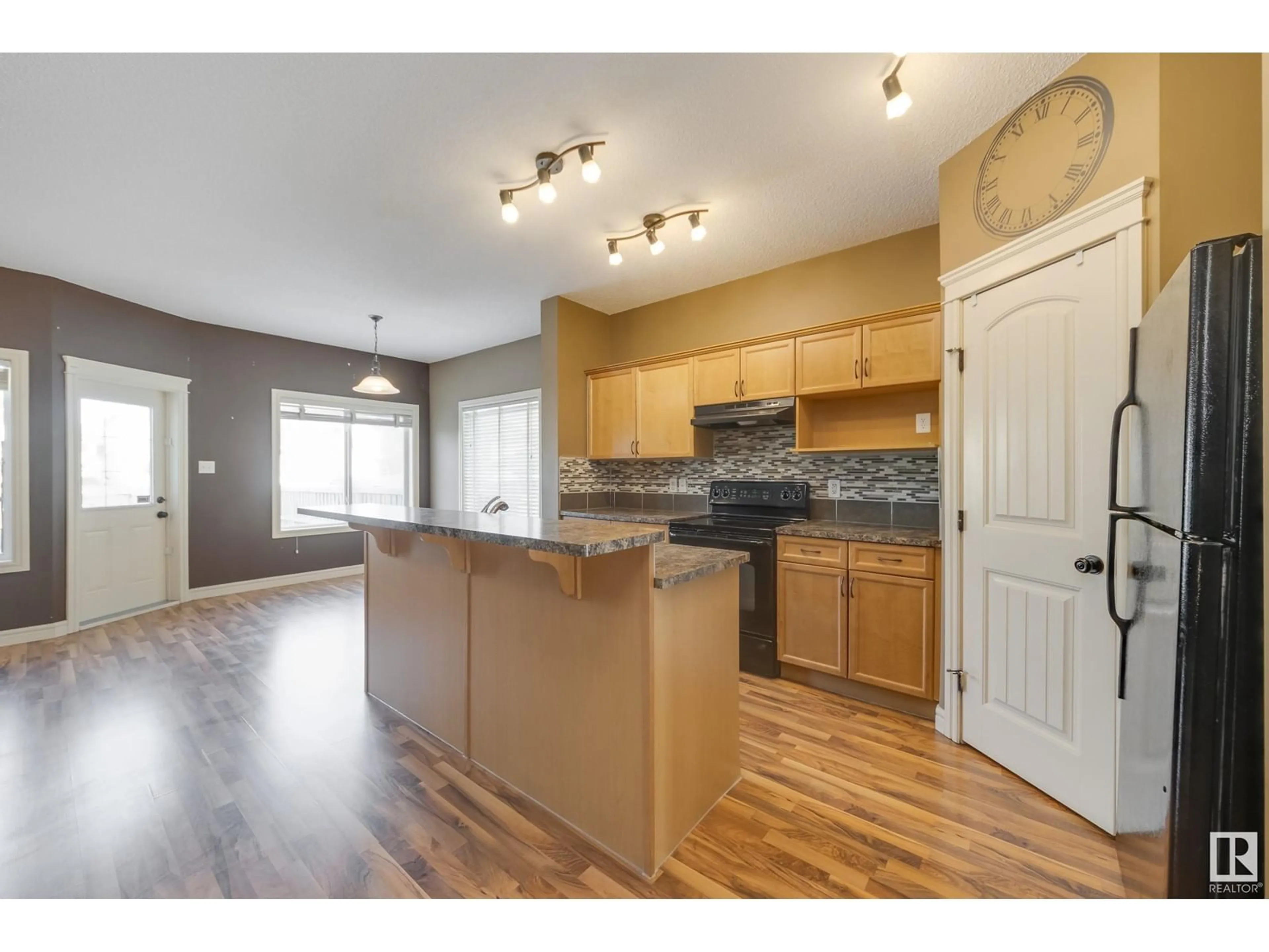 Open concept kitchen, wood/laminate floor for 11836 21 AV SW, Edmonton Alberta T6W0C9