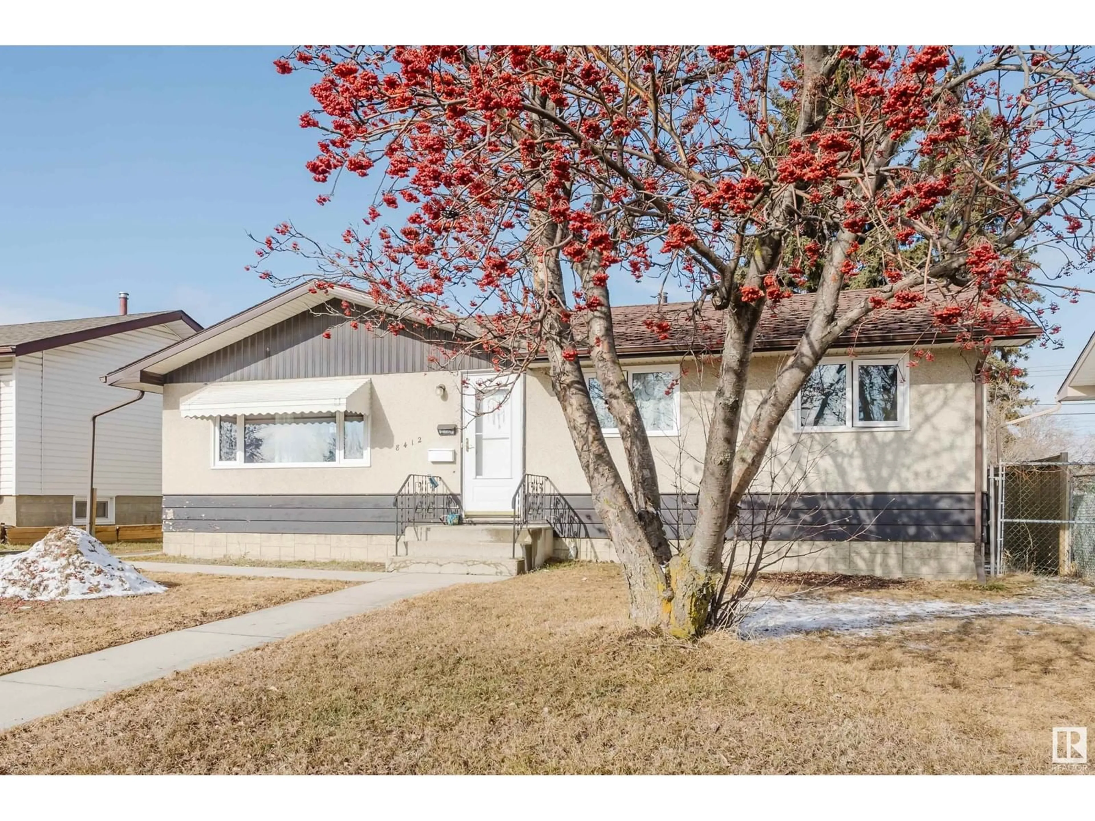 Home with vinyl exterior material, street for 8412 134 AV NW, Edmonton Alberta T5E1H2