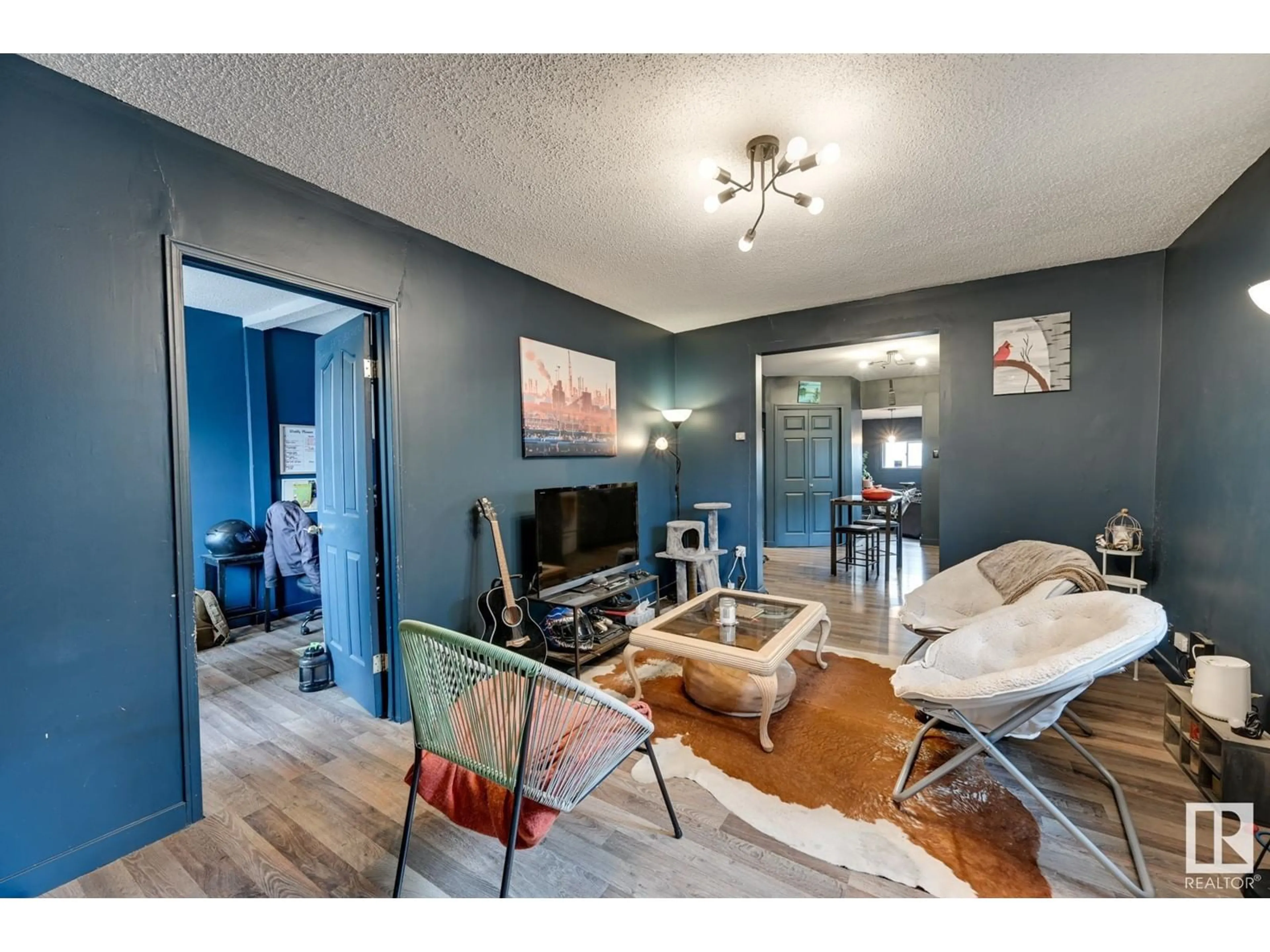 Living room with furniture, wood/laminate floor for 11911 77 ST NW, Edmonton Alberta T5B2G5