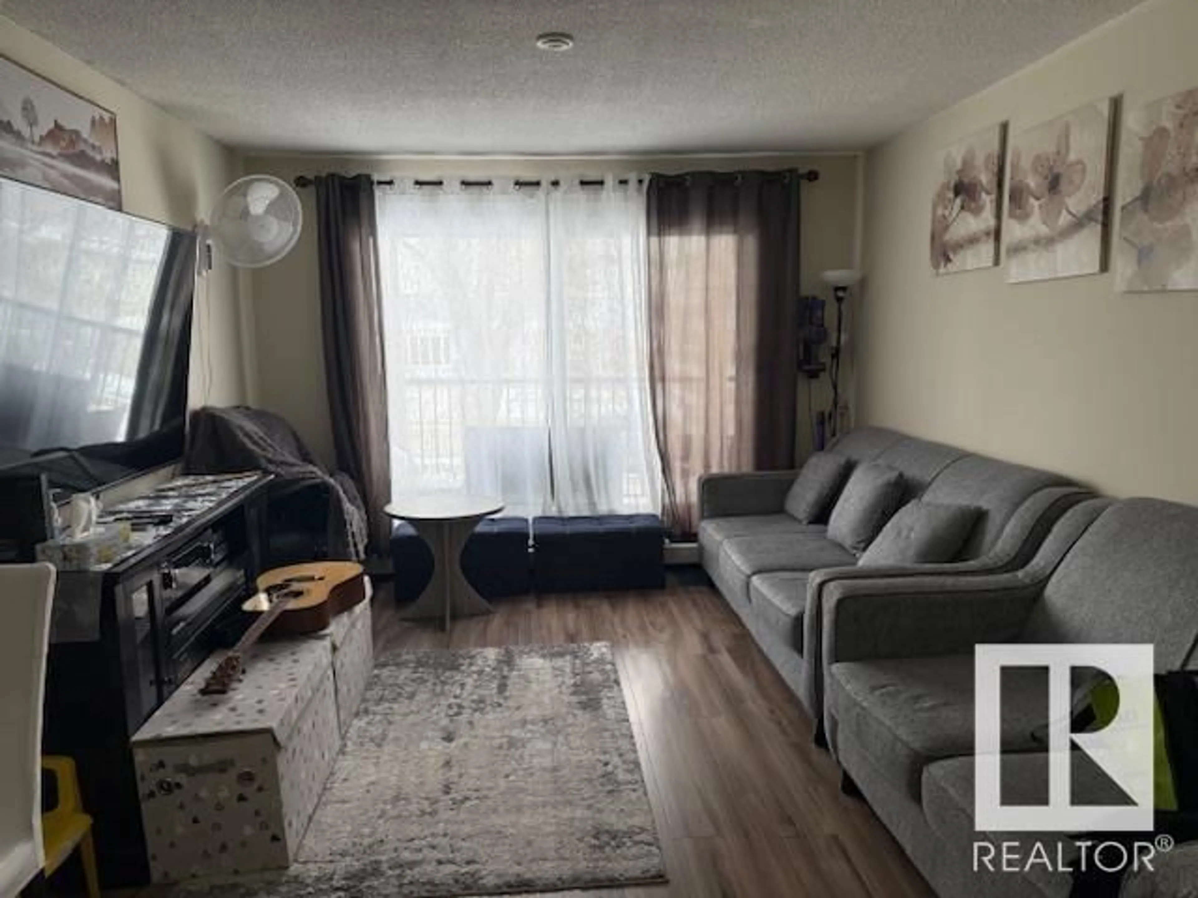 Living room with furniture, wood/laminate floor for #15C 5715 133 AV NW, Edmonton Alberta T5A1C2