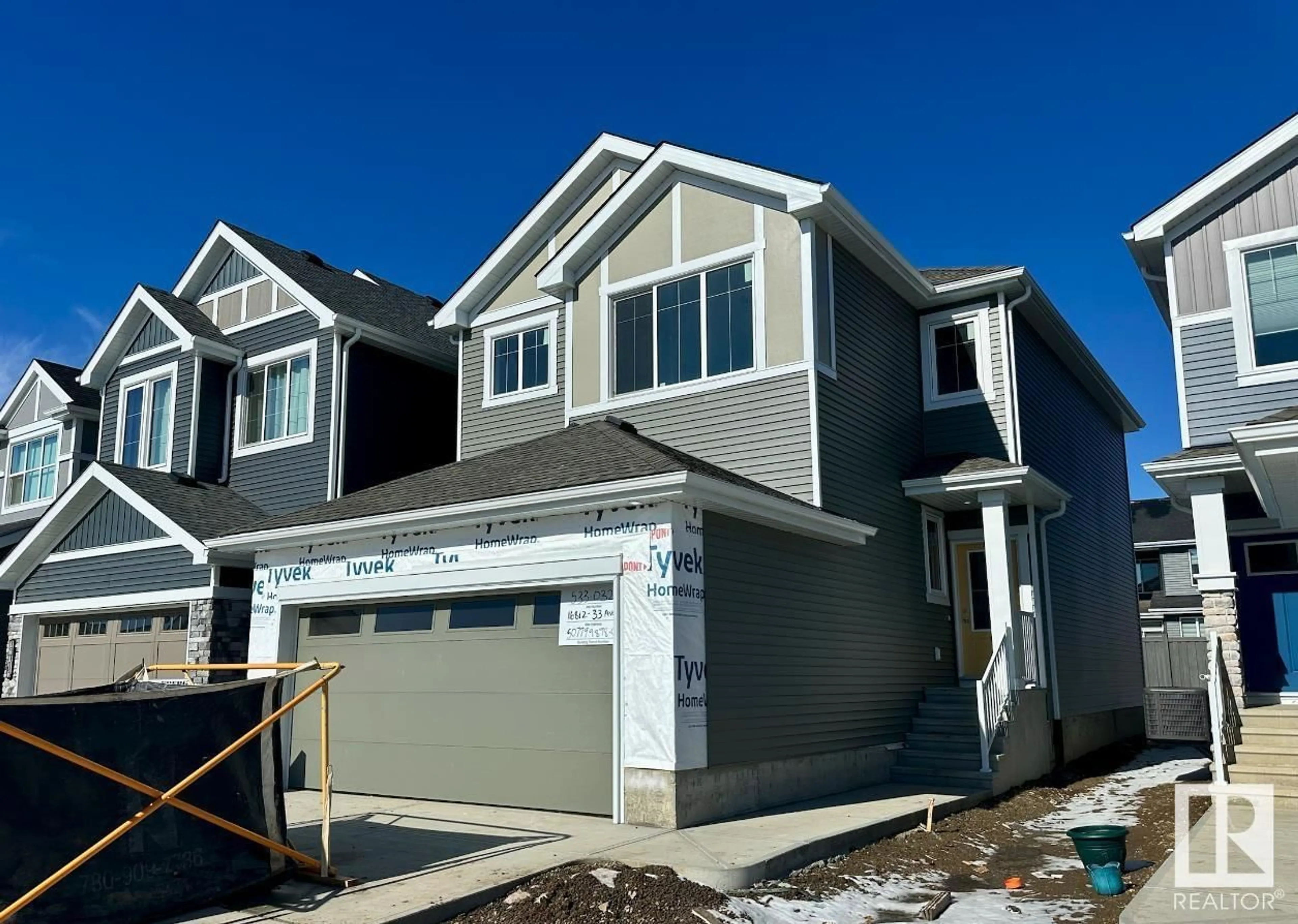 Home with vinyl exterior material, street for 16812 33 AV SW, Edmonton Alberta T6W5M3