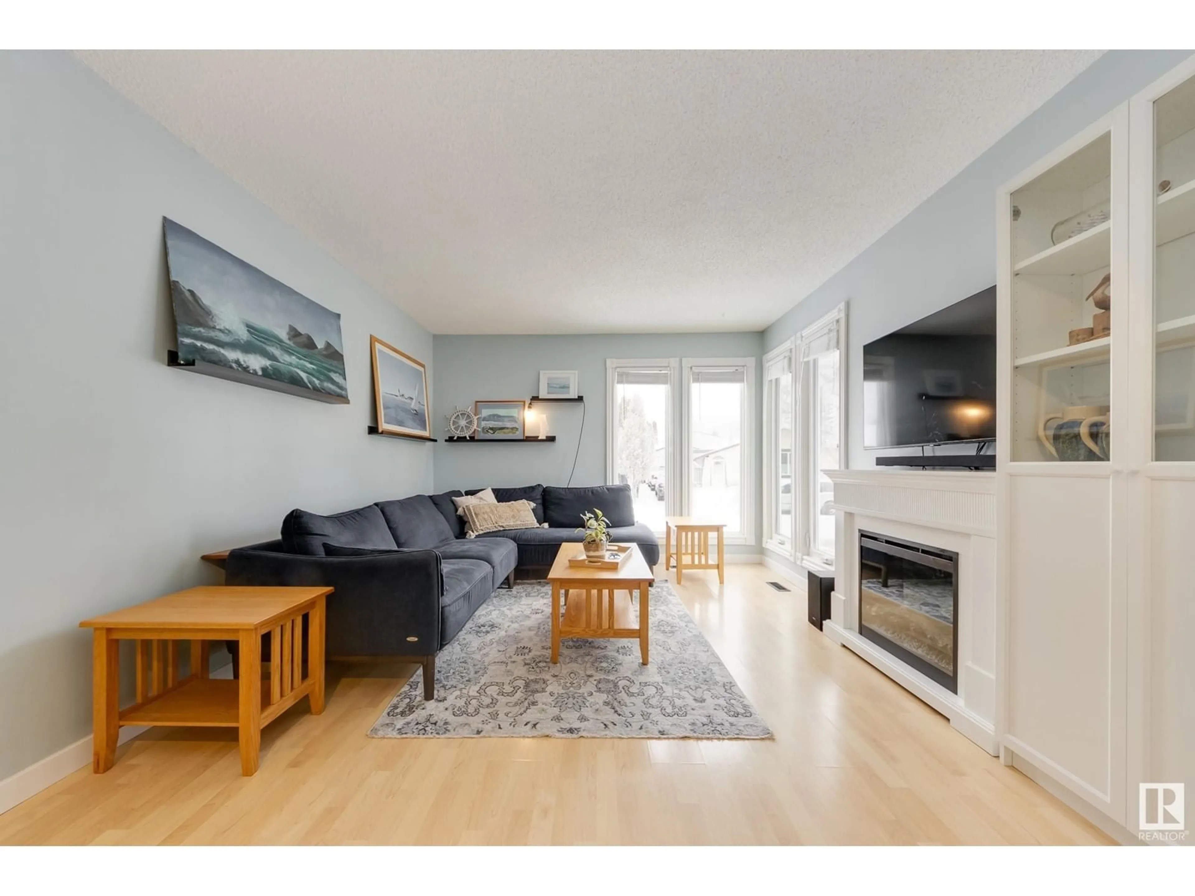 Living room with furniture, wood/laminate floor for 8411 26 AV NW, Edmonton Alberta T6K2W8