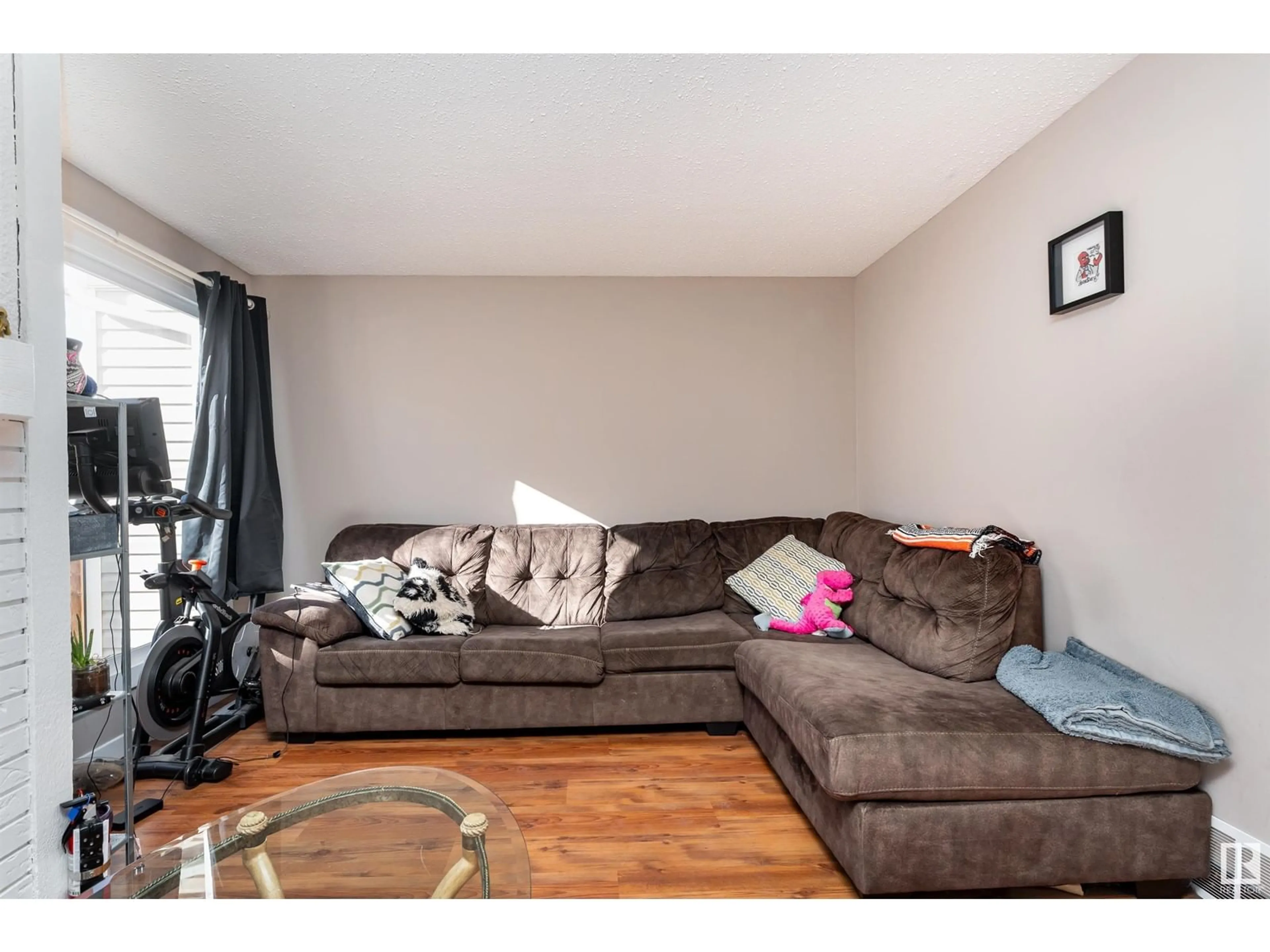 Living room with furniture, wood/laminate floor for 473 DUNLUCE RD NW, Edmonton Alberta T5X2L9