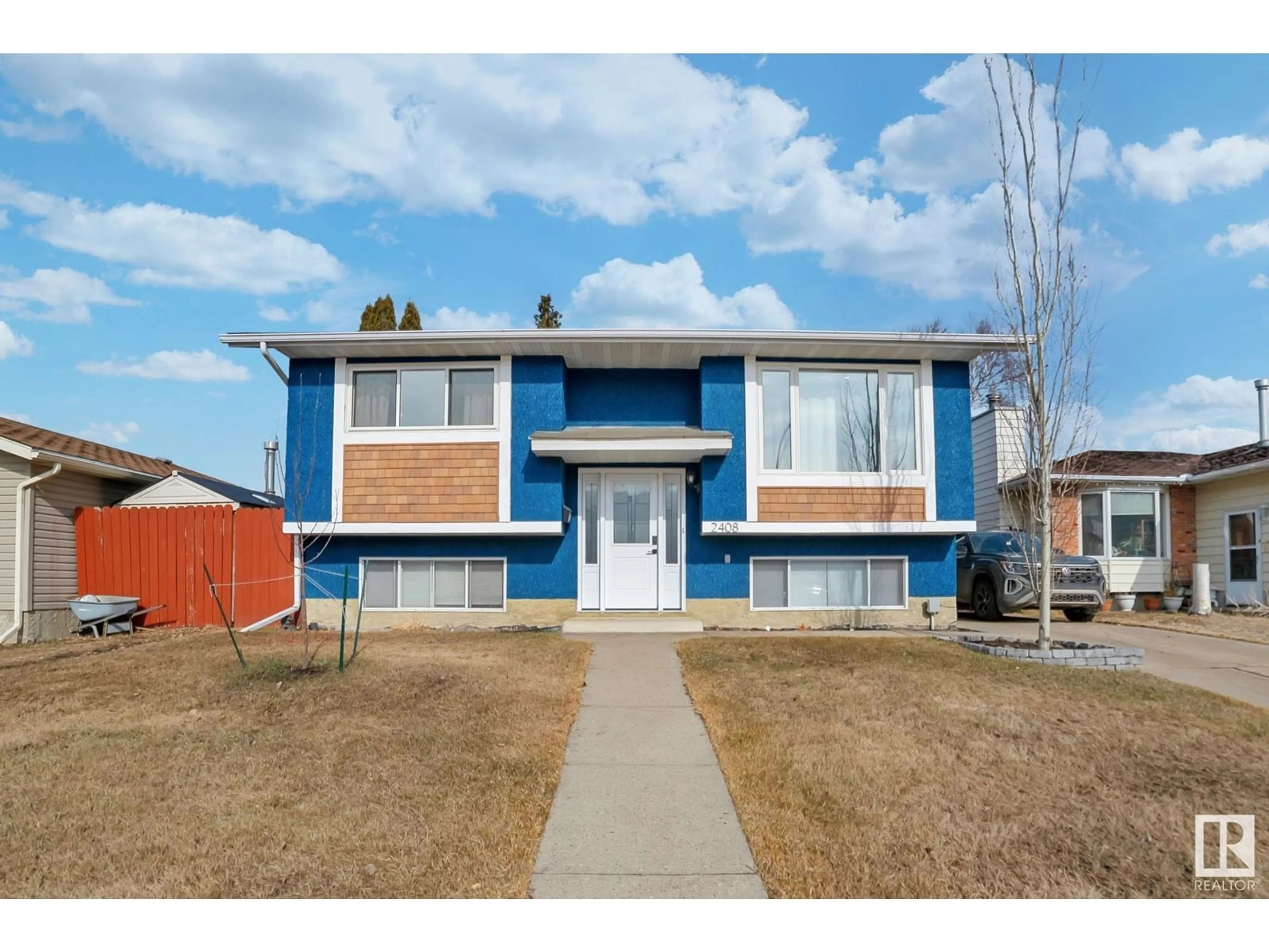 Home with vinyl exterior material, street for 2408 133 AVE NW, Edmonton Alberta T5A4K1