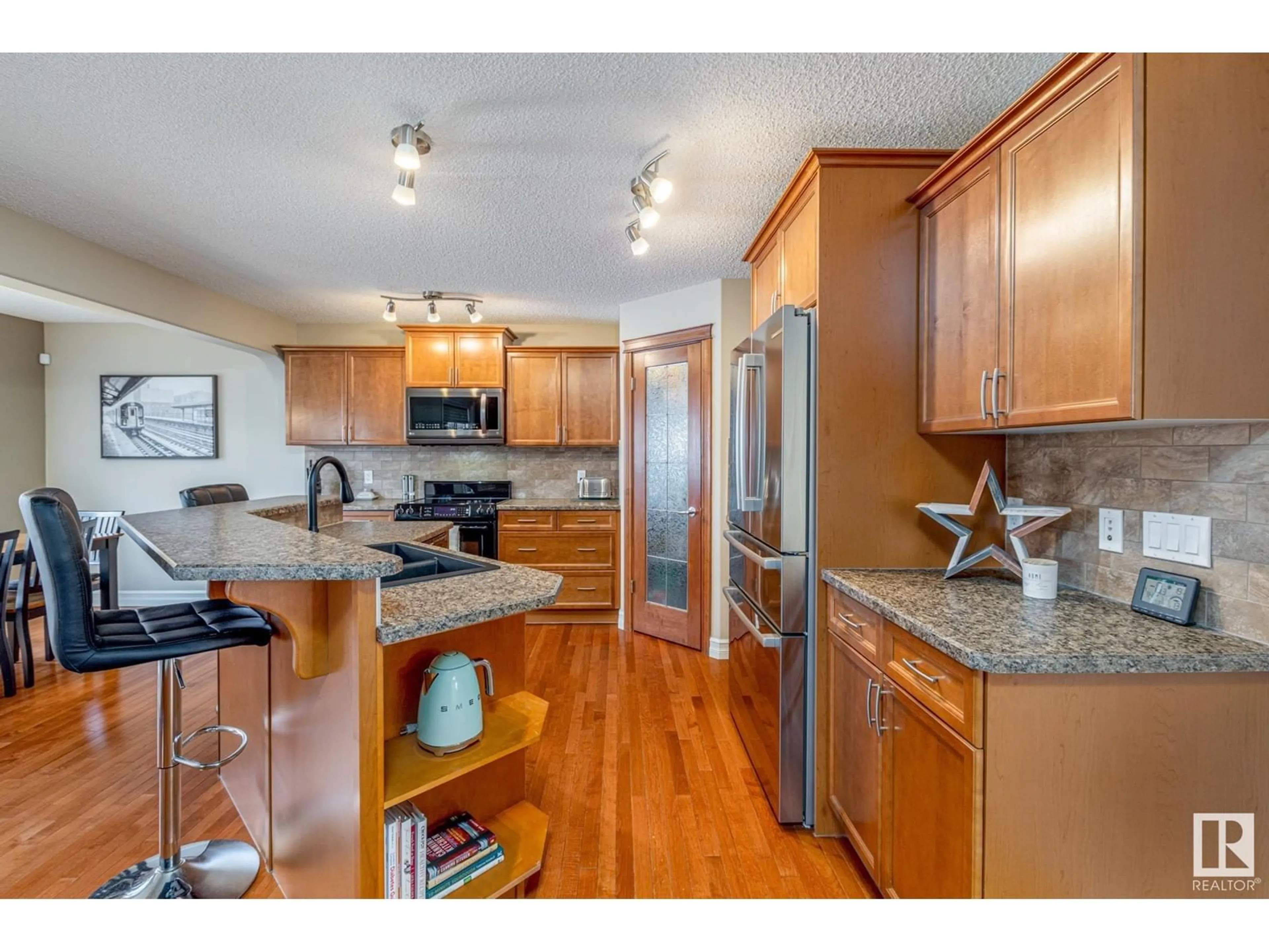 Open concept kitchen, wood/laminate floor for 604 Foxtail Lane, Sherwood Park Alberta T8A3C2