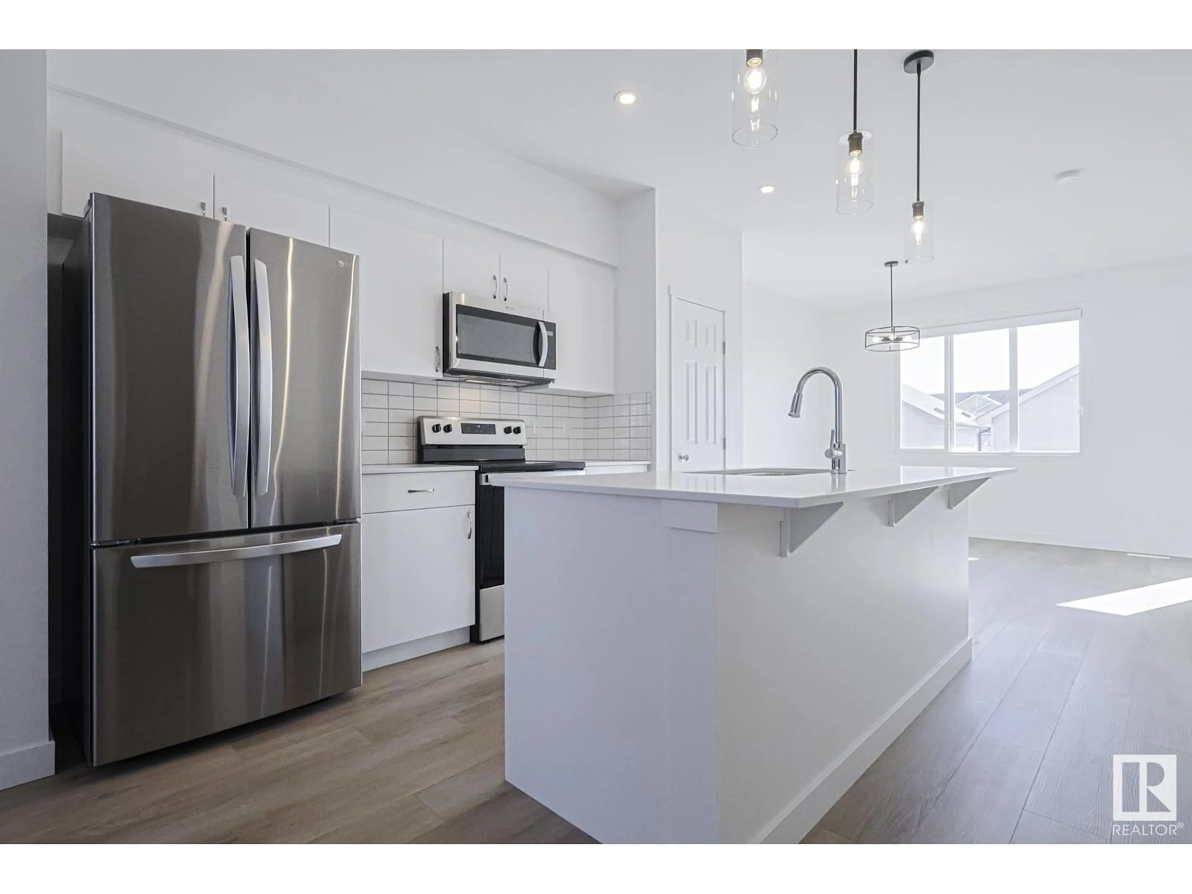 Open concept kitchen, wood/laminate floor for 6347 KING WD SW, Edmonton Alberta T6W5P1