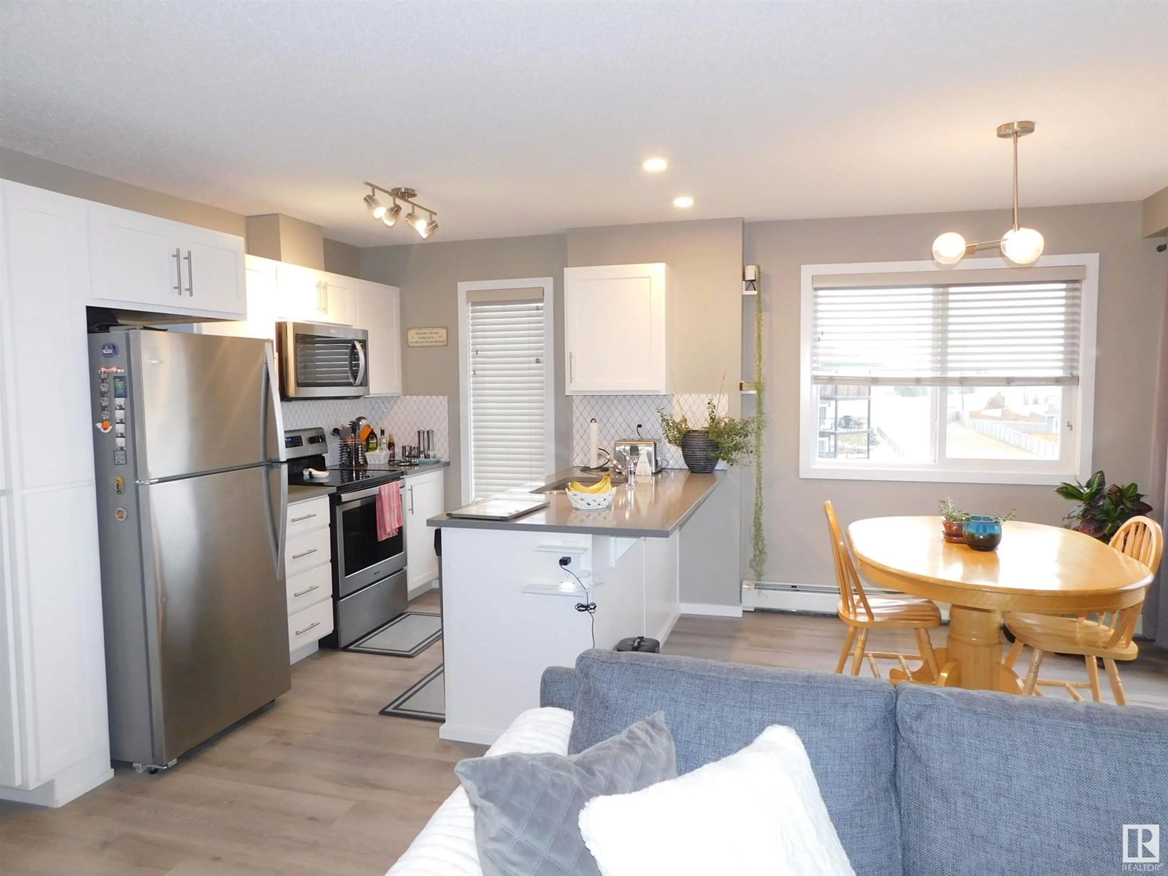 Open concept kitchen, wood/laminate floor for #421 148 EBBERS BV NW, Edmonton Alberta T5Y4A4