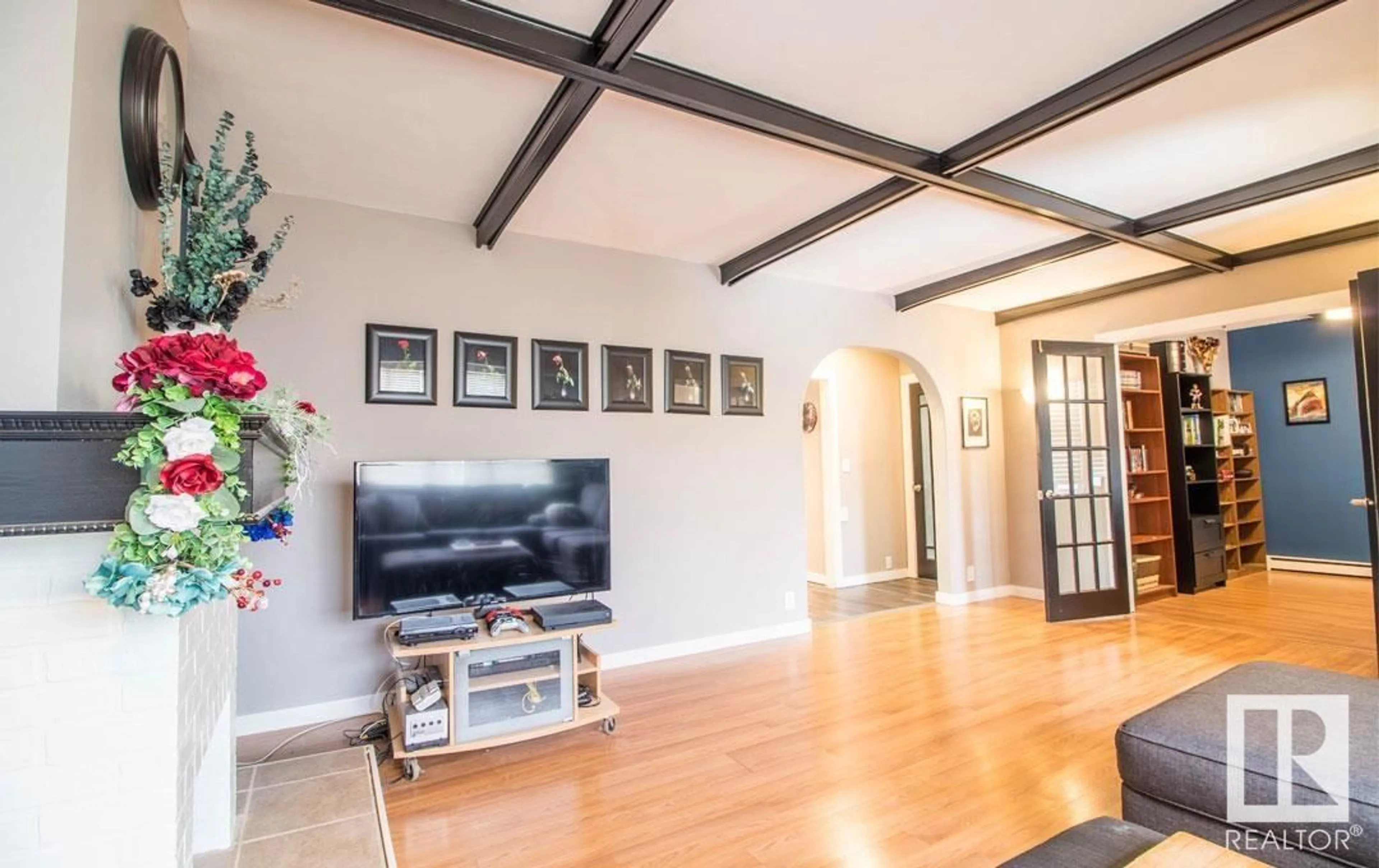 Living room with furniture, wood/laminate floor for 11239 105 ST, Edmonton Alberta T5G2M4