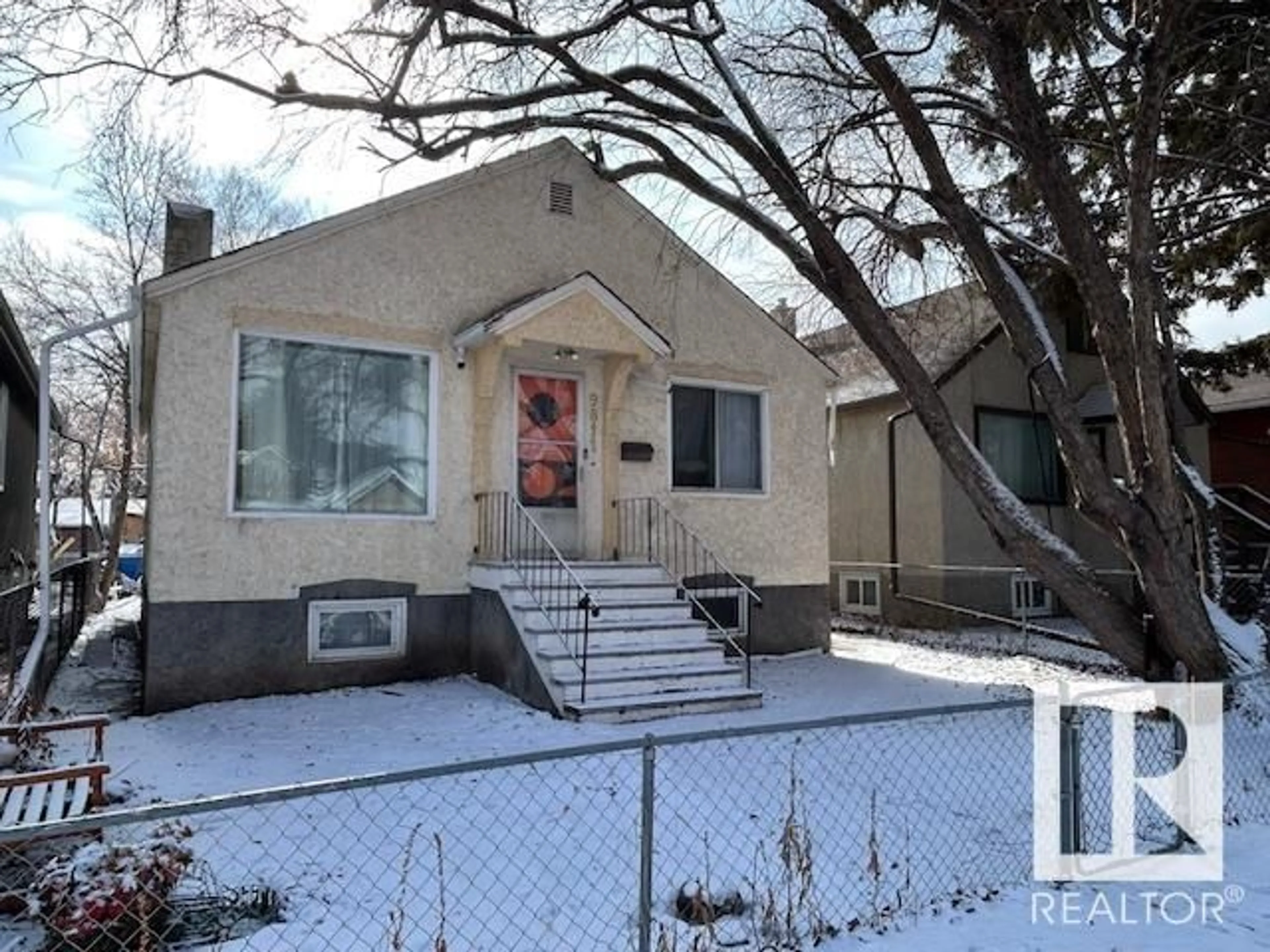 Home with vinyl exterior material, street for 9811 78 AV NW, Edmonton Alberta T6E1N4