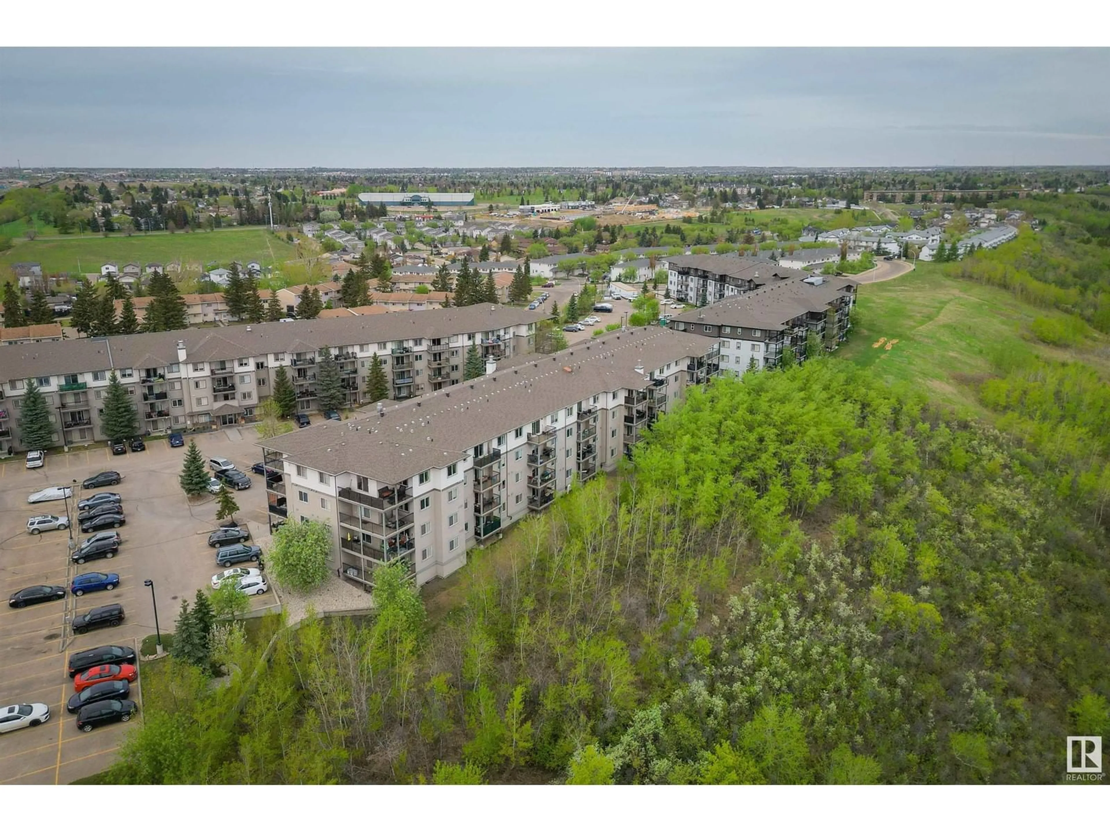 A pic from outside/outdoor area/front of a property/back of a property/a pic from drone, mountain view for 1188 - 110 HYNDMAN RD, Edmonton Alberta T5A0E9