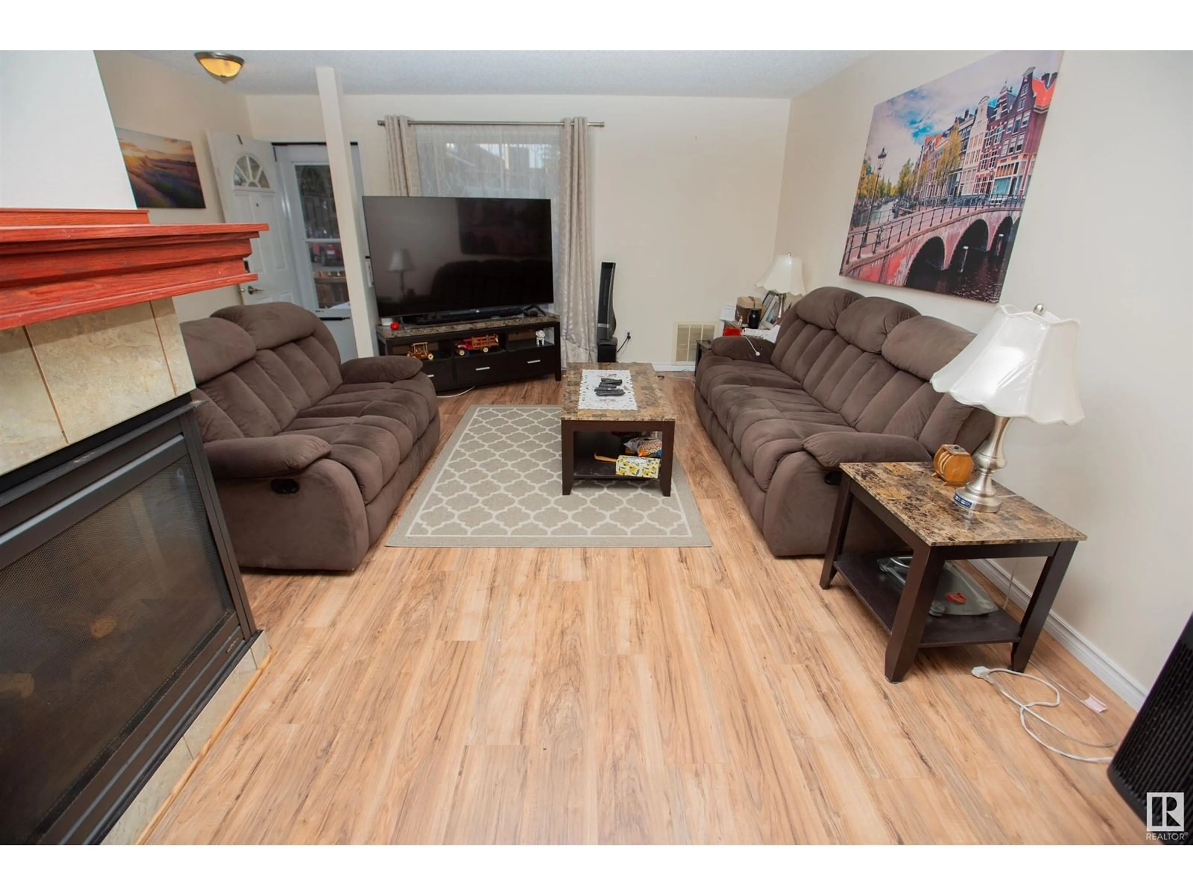 Living room with furniture, wood/laminate floor for #8 3111 142 AV NW, Edmonton Alberta T5Y2H6