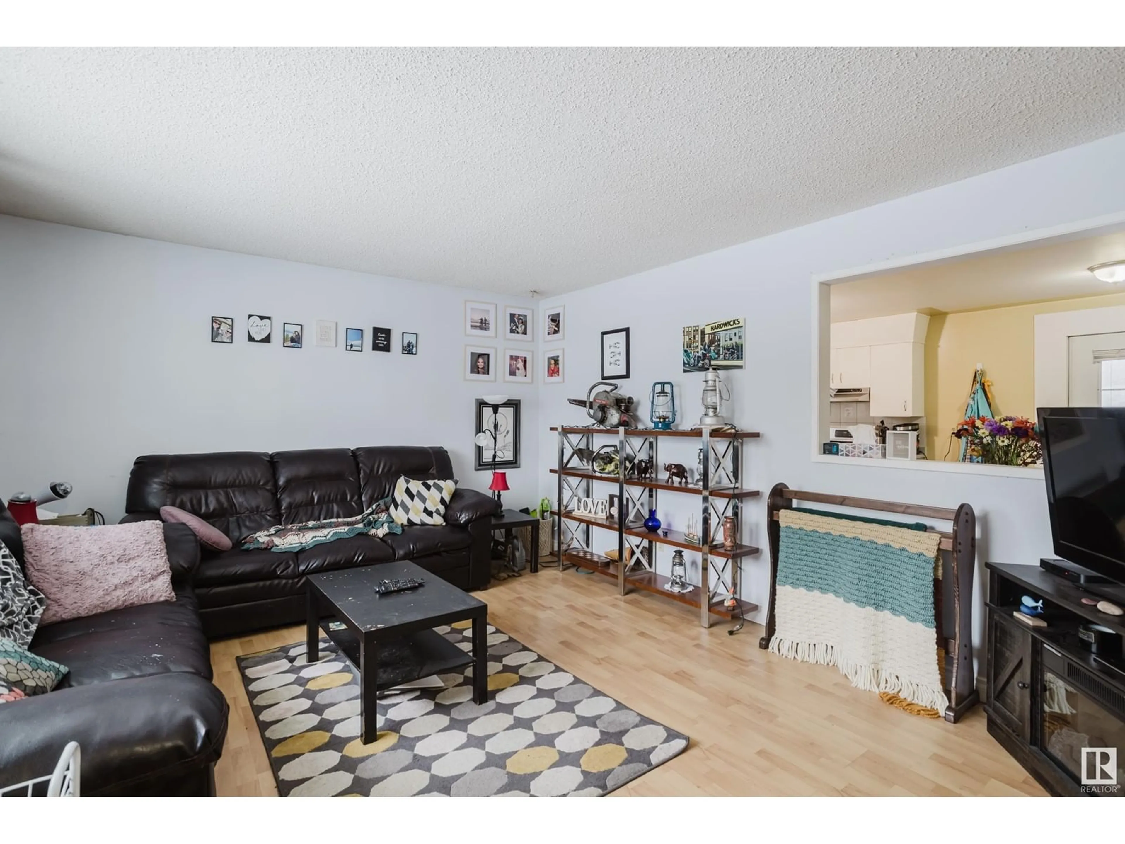 Living room with furniture, wood/laminate floor for 1115 87 ST NW, Edmonton Alberta T6K1X9