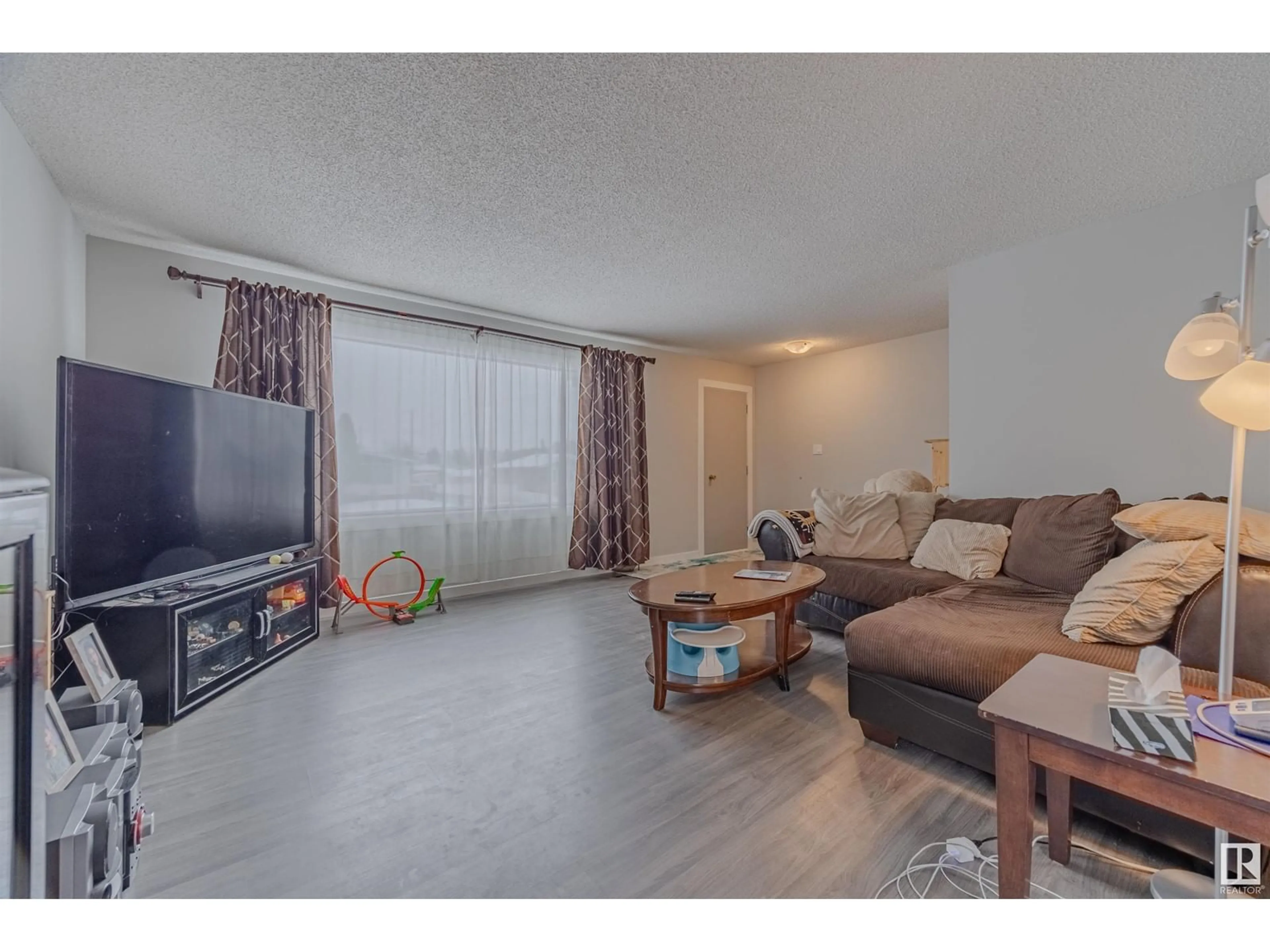 Living room with furniture, wood/laminate floor for 13305 68 ST NW NW, Edmonton Alberta T5C0G1