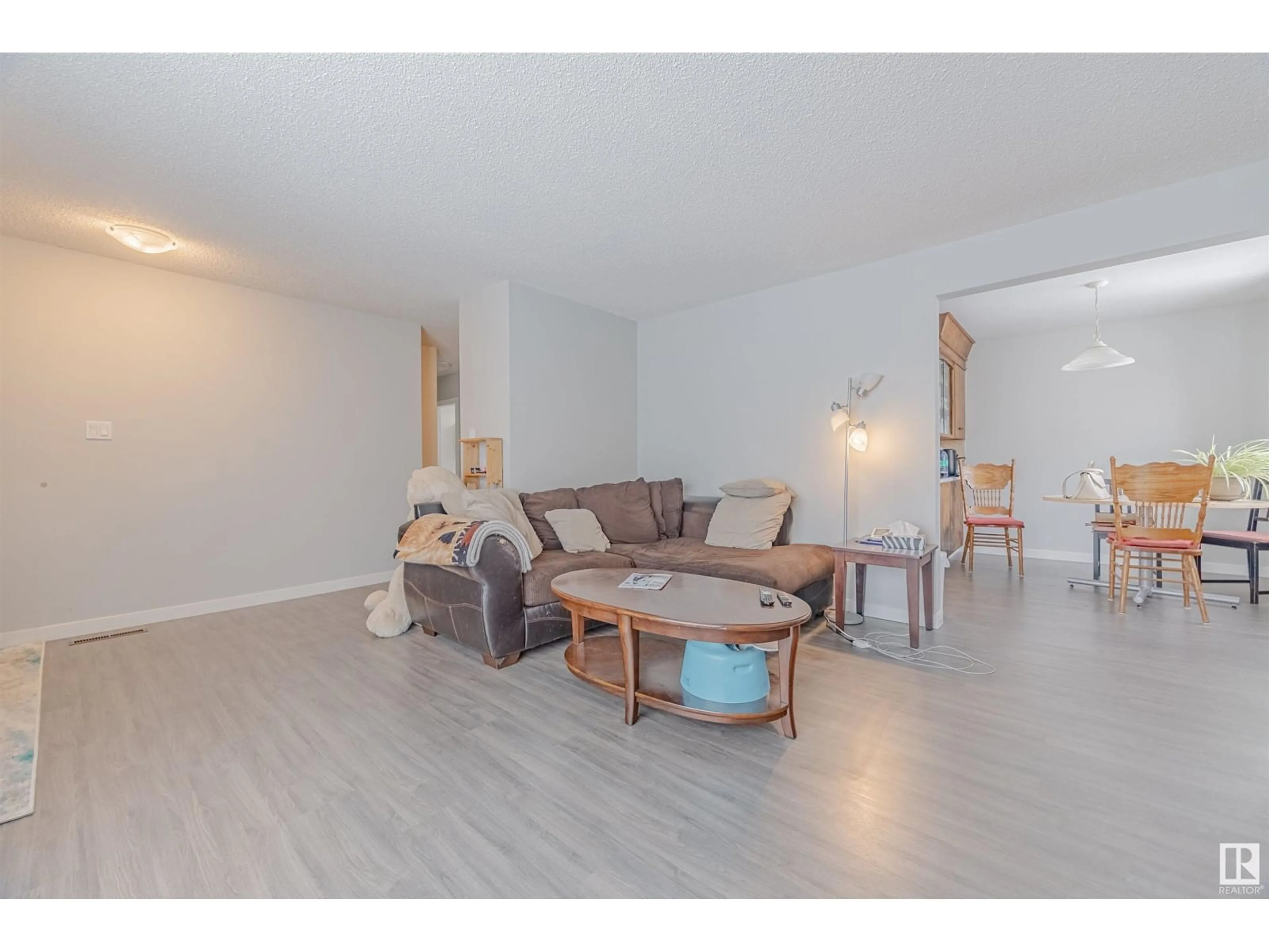 Living room with furniture, wood/laminate floor for 13305 68 ST NW NW, Edmonton Alberta T5C0G1