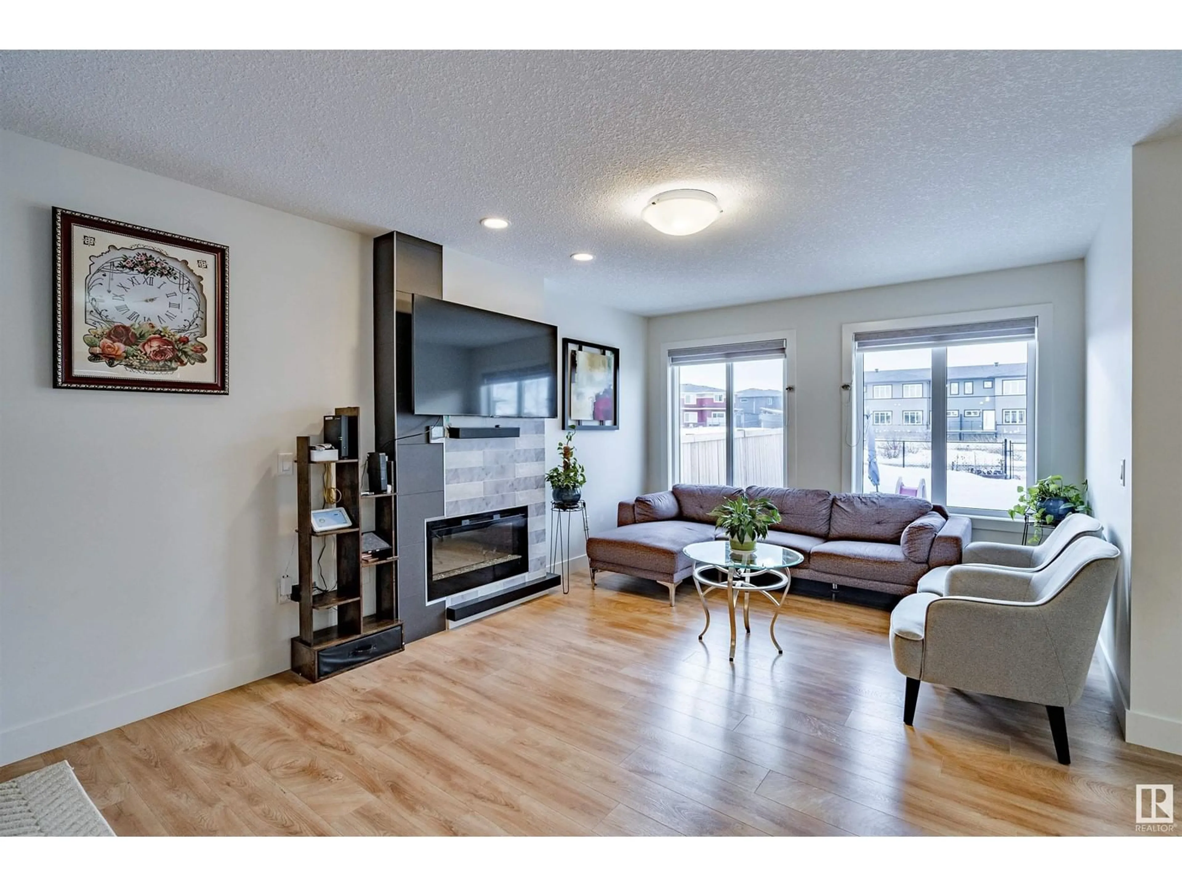 Living room with furniture, wood/laminate floor for 5718 HAWTHORN CM SW, Edmonton Alberta T6X2L5