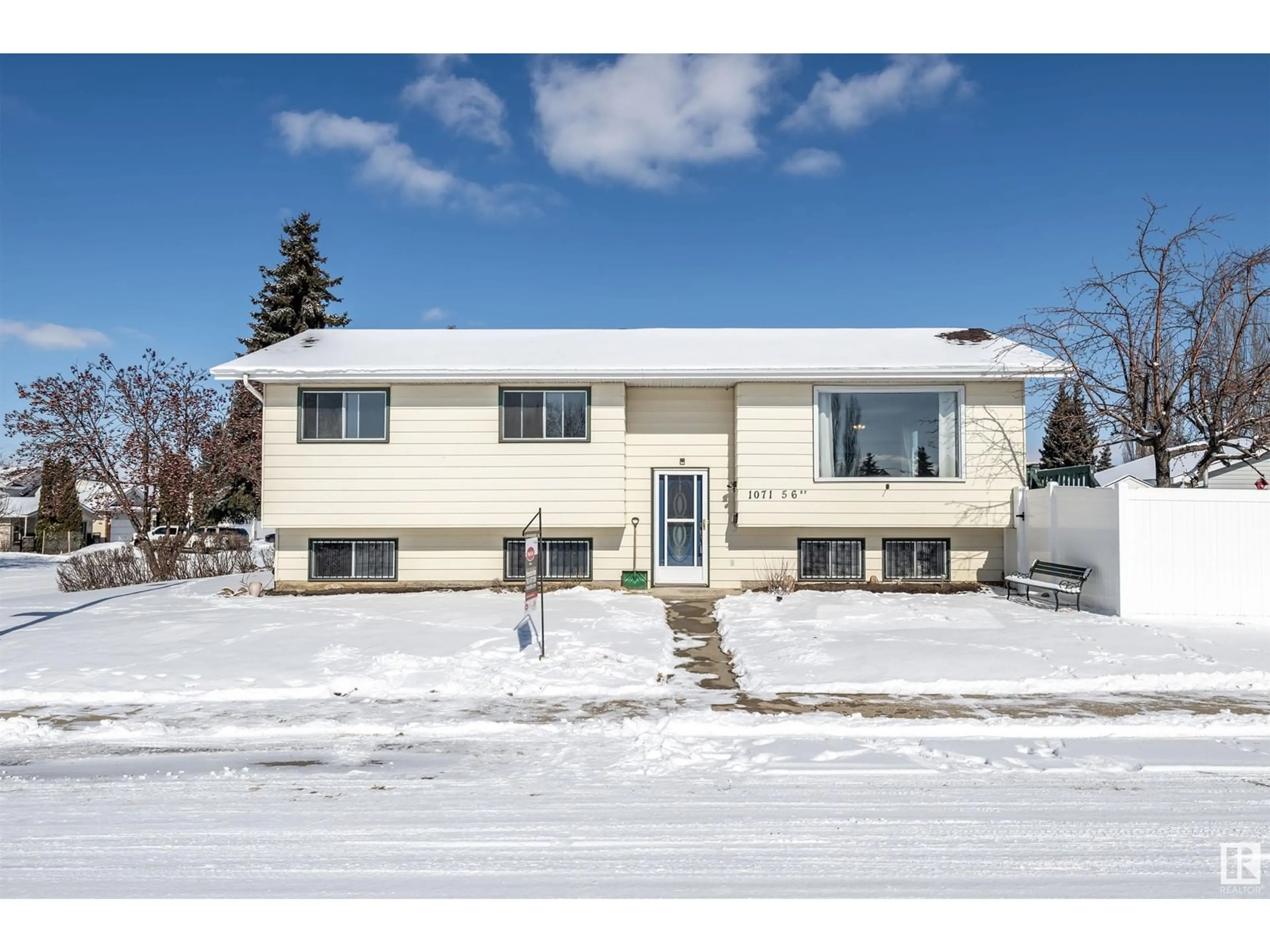 Home with vinyl exterior material, street for 1071 56 ST NW, Edmonton Alberta T6L1Y4