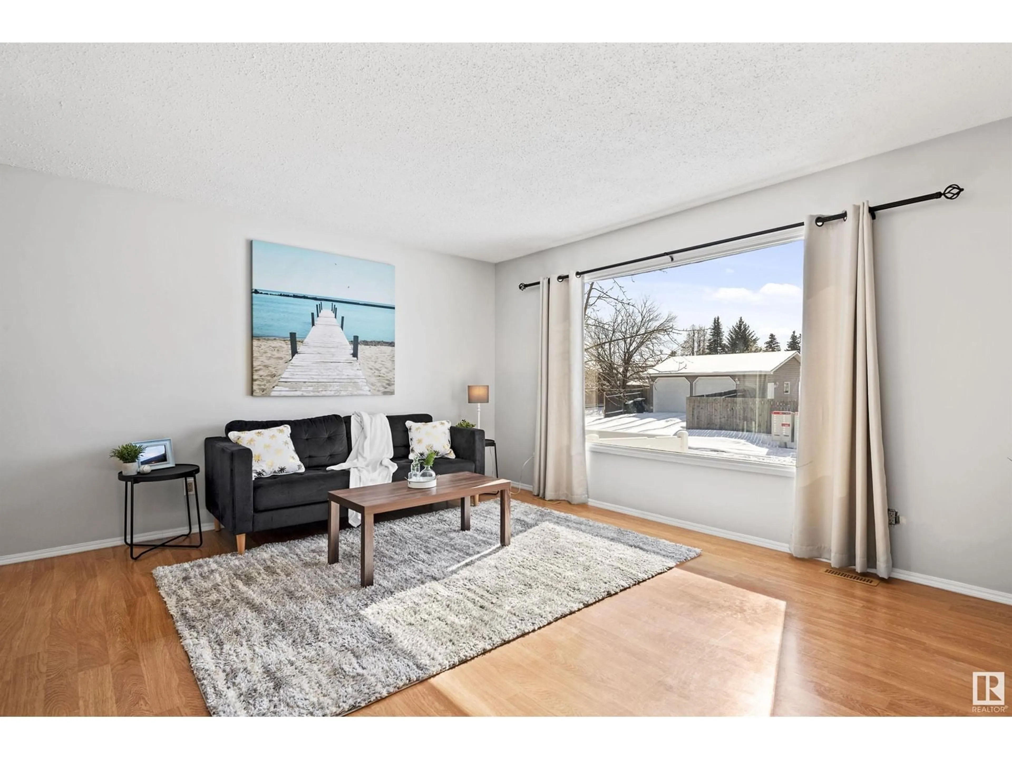 Living room with furniture, wood/laminate floor for 1071 56 ST NW, Edmonton Alberta T6L1Y4