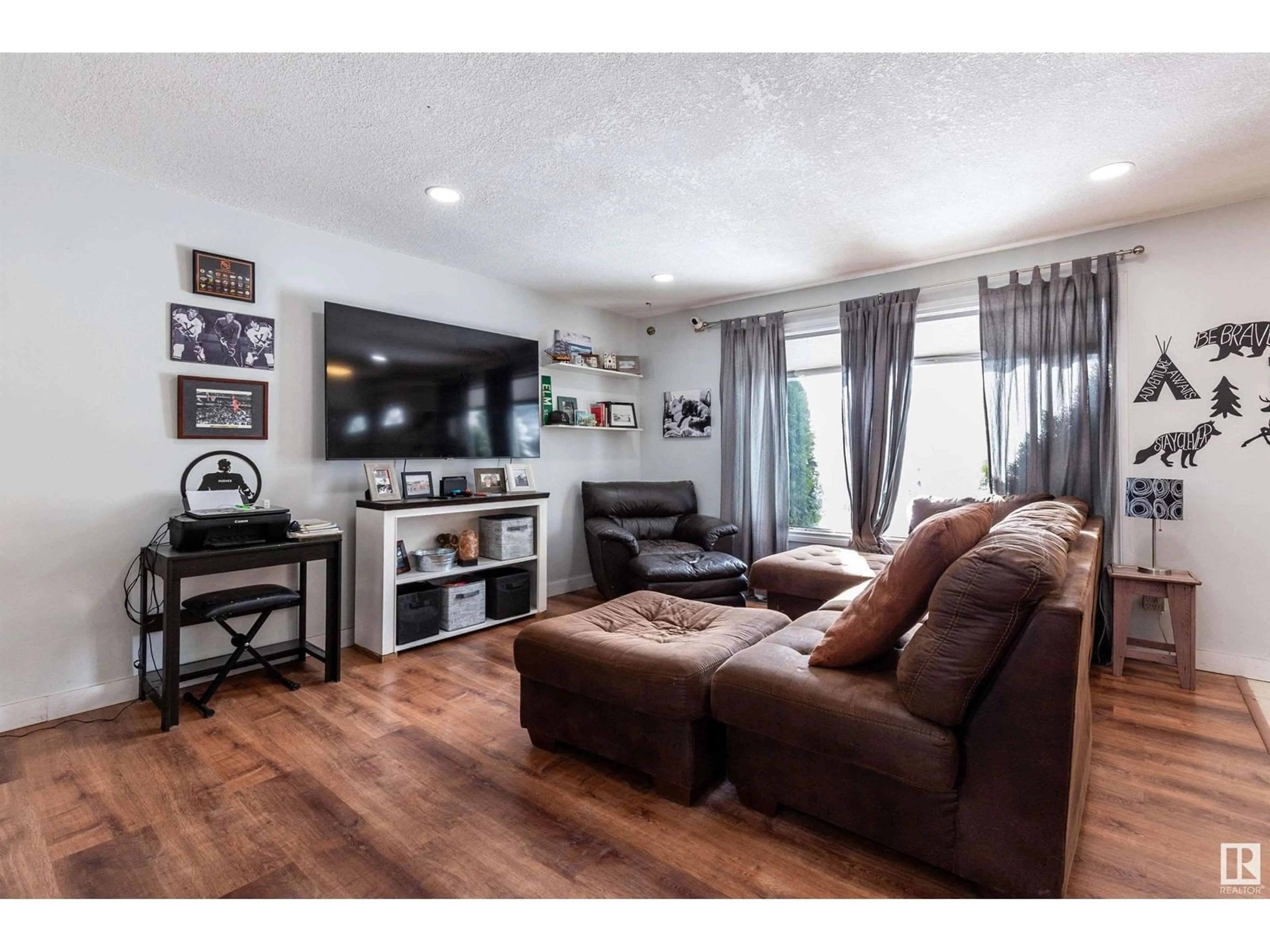 Living room with furniture, wood/laminate floor for 4916 50A AV, Entwistle Alberta T0E0S0