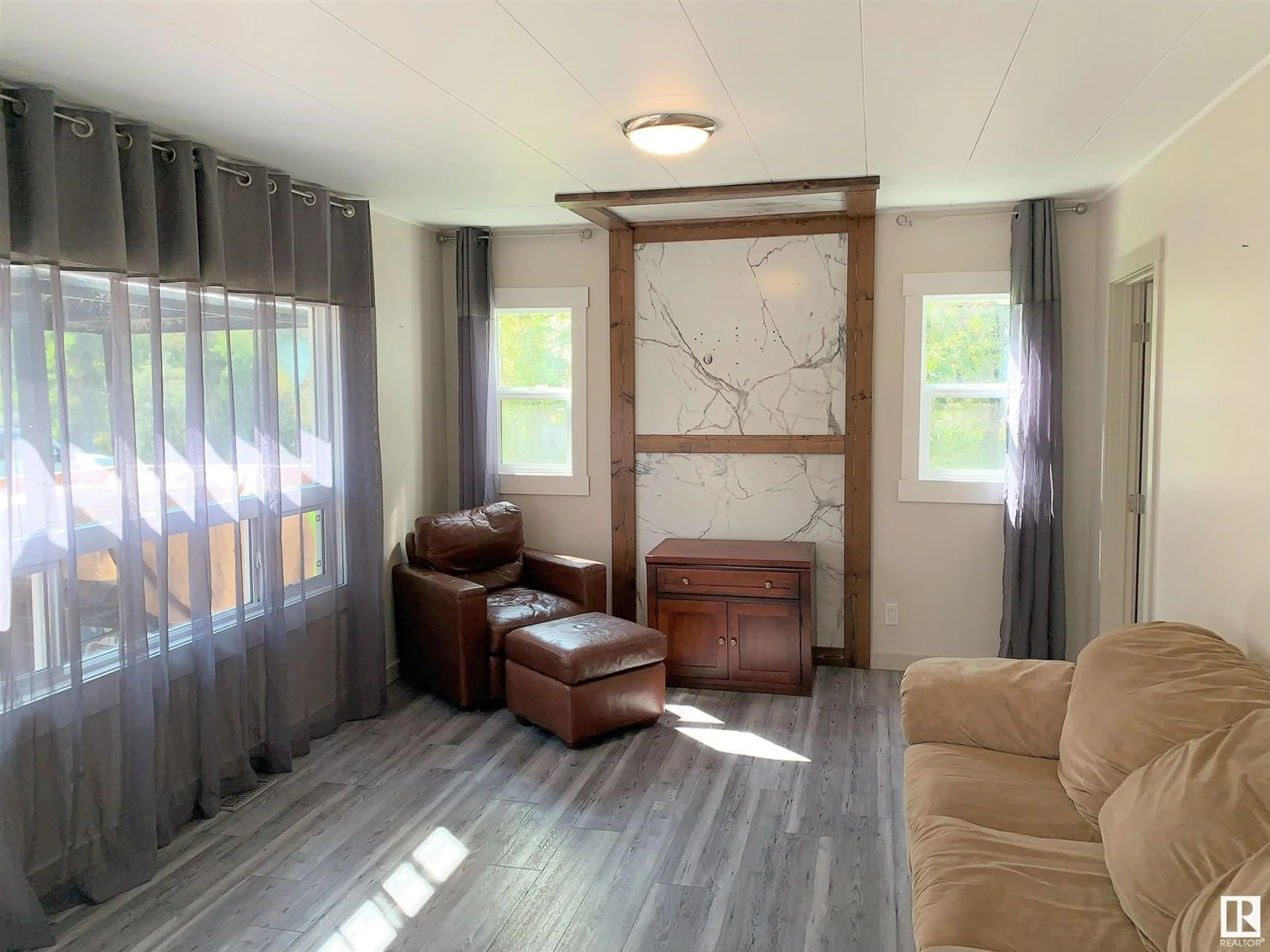 Living room with furniture, wood/laminate floor for 47436 - 1270 RR 15 MISSION BEACH, Rural Leduc County Alberta T0C2P0
