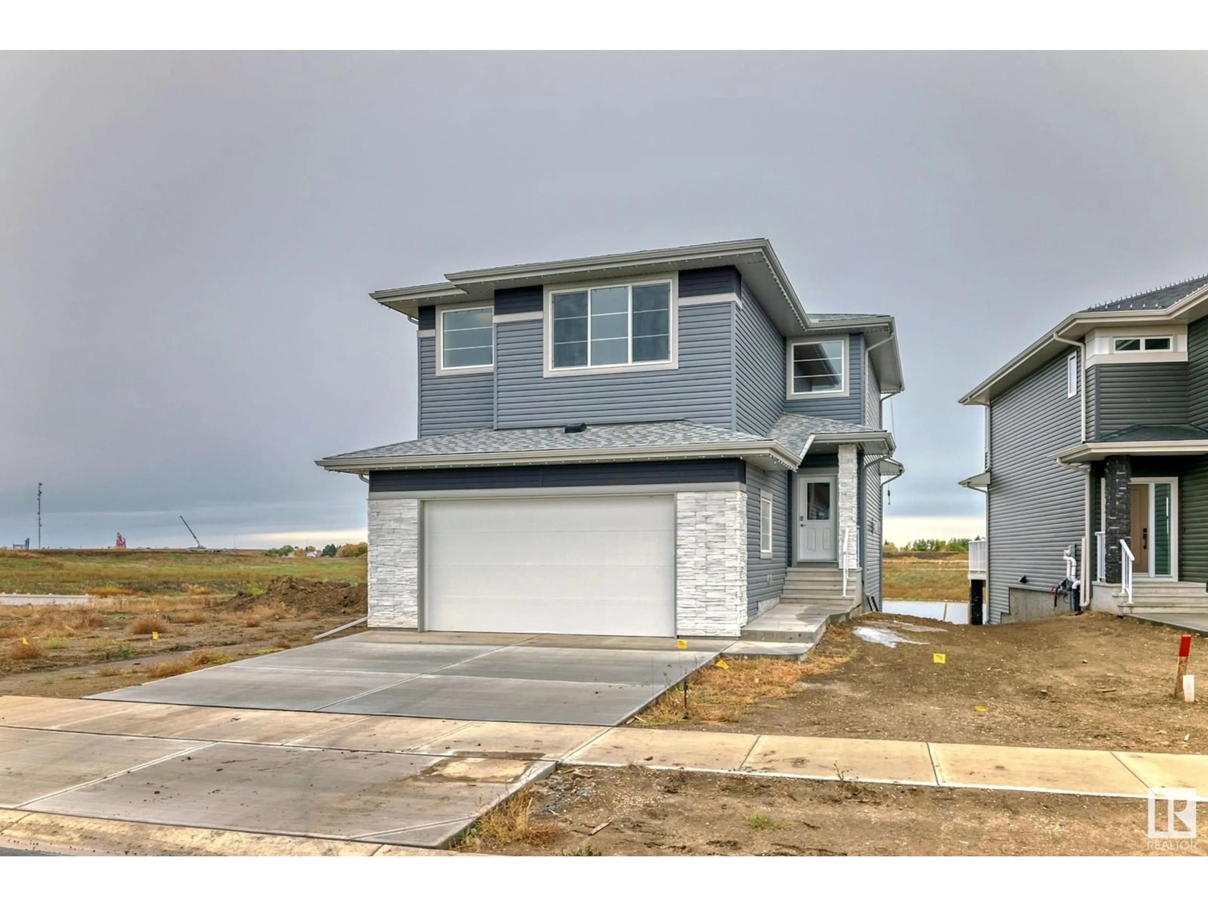 Home with vinyl exterior material, street for 10238 92A AV, Morinville Alberta T8R2R4