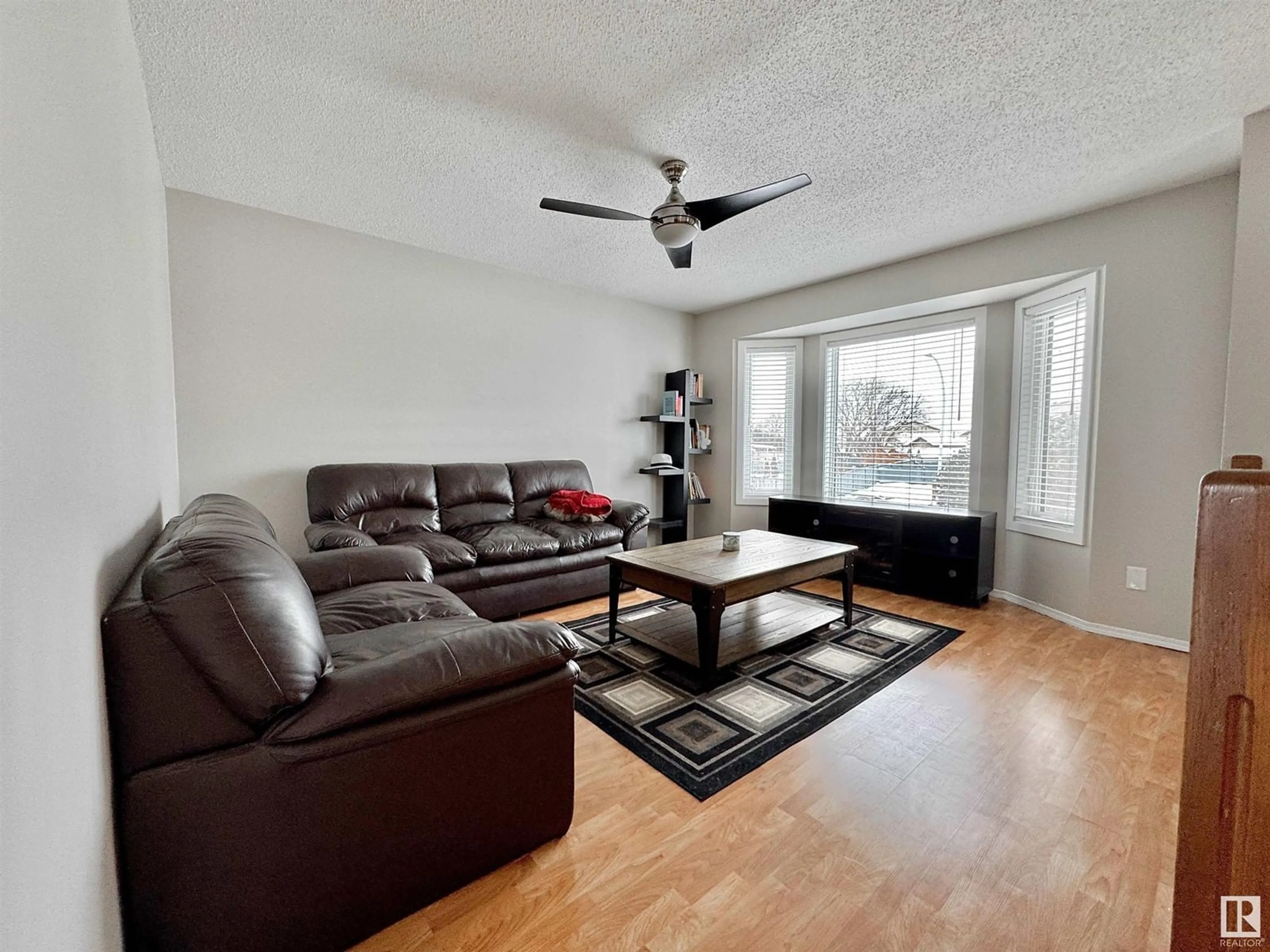 Living room with furniture, wood/laminate floor for NW - 14723 35 ST, Edmonton Alberta T5Y2H8