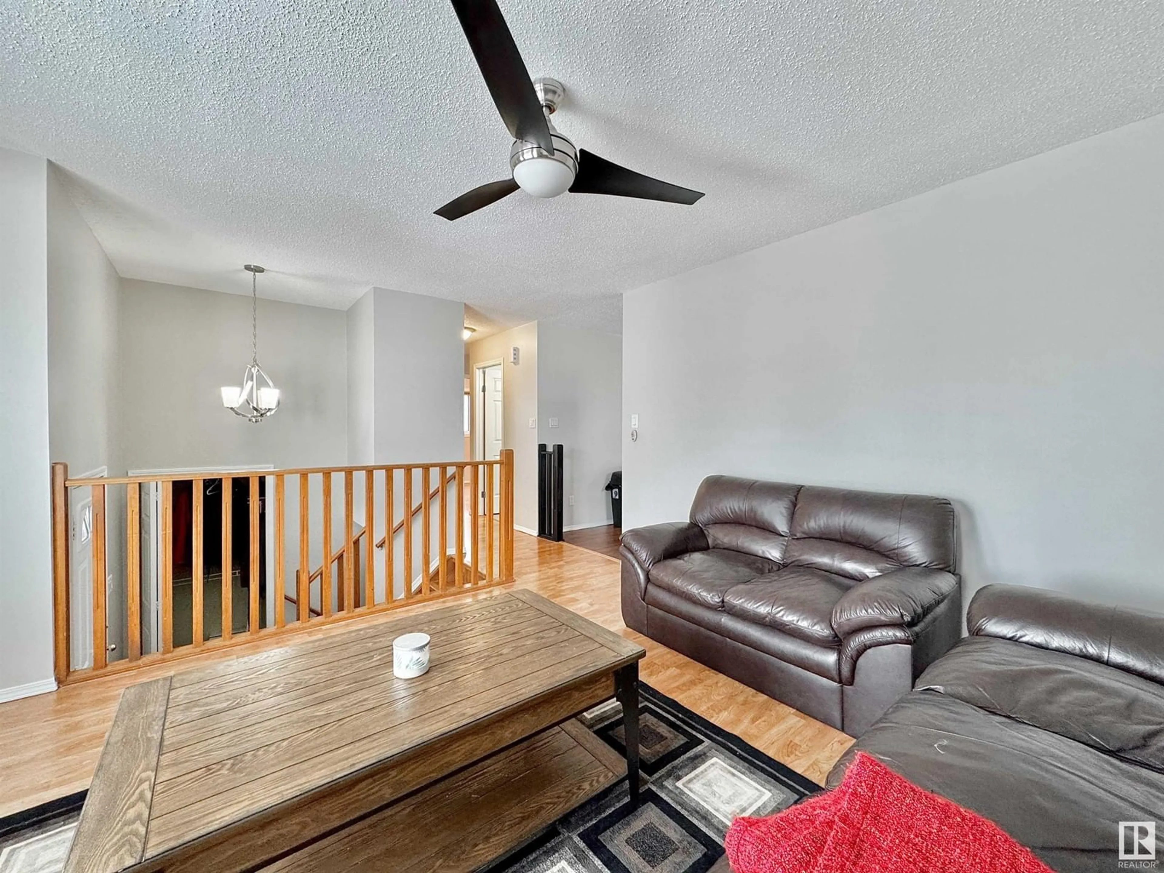 Living room with furniture, wood/laminate floor for NW - 14723 35 ST, Edmonton Alberta T5Y2H8