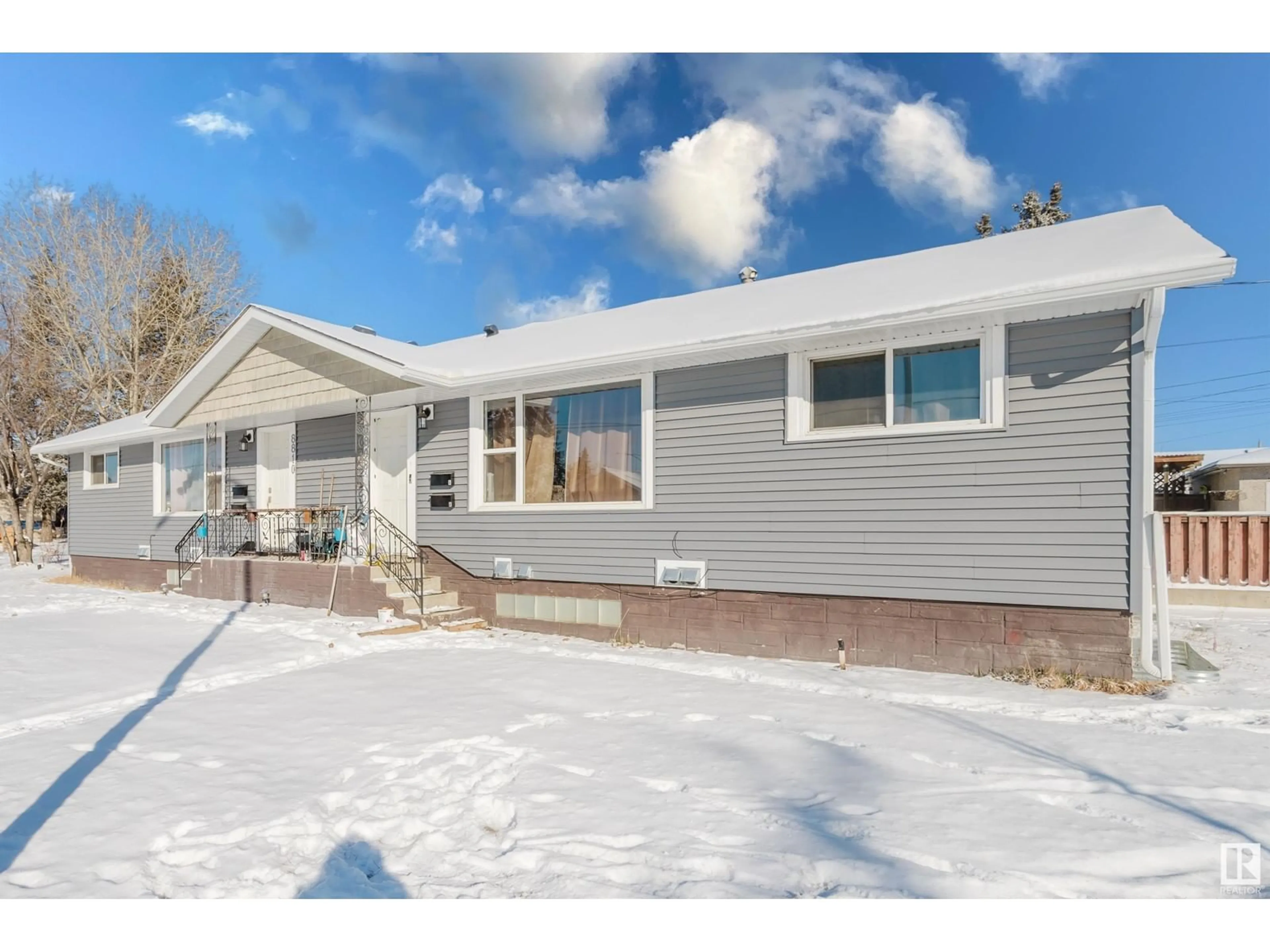 Home with vinyl exterior material, street for 10 - 8808 128 AV, Edmonton Alberta T5E0G6