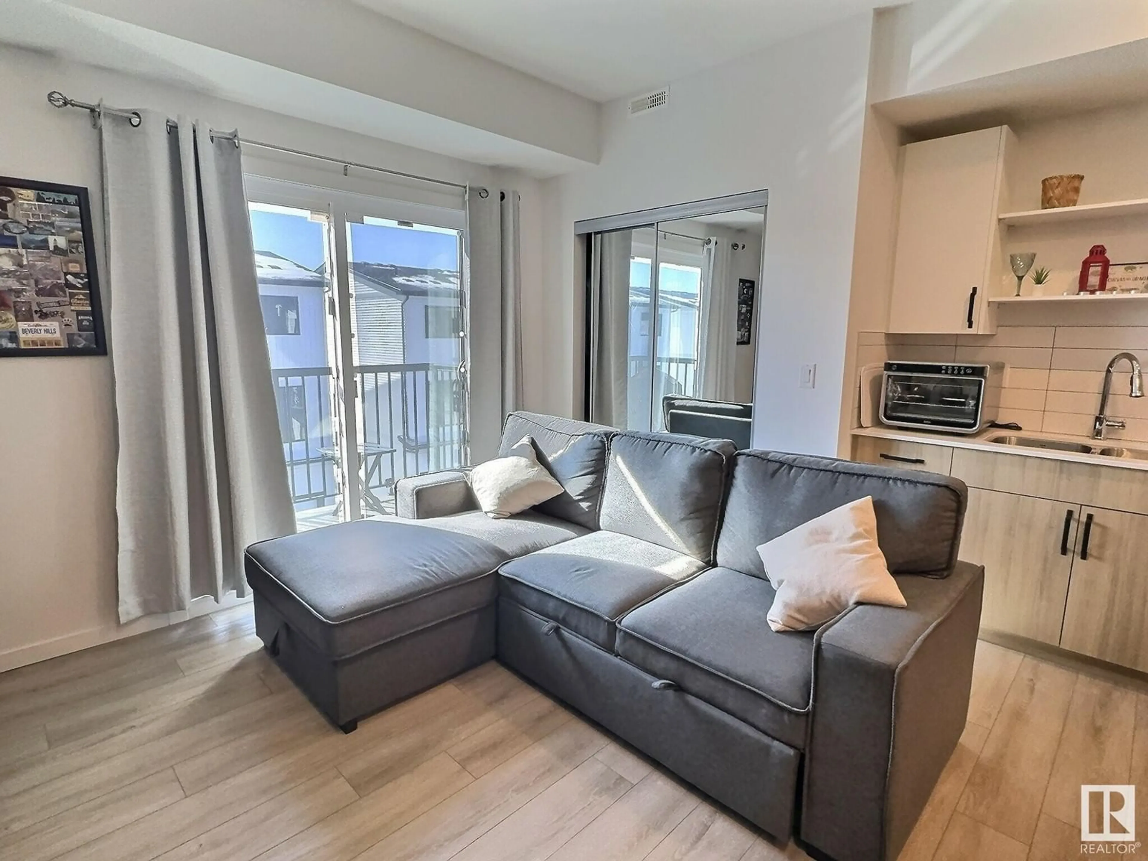 Living room with furniture, wood/laminate floor for #305 - 864 SECORD BV, Edmonton Alberta T5T7R9