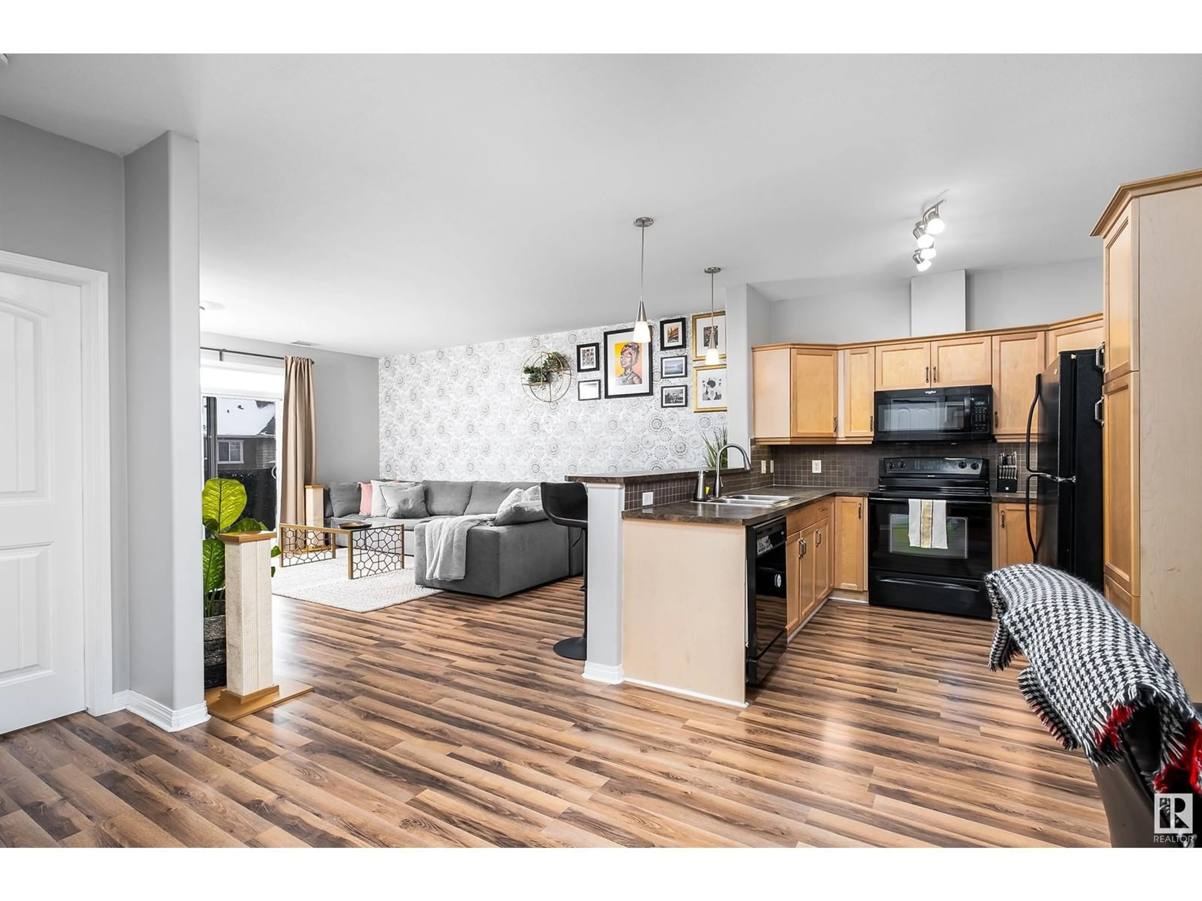 Open concept kitchen, wood/laminate floor for #304 2503 Hanna CR NW, Edmonton Alberta T6R0H1