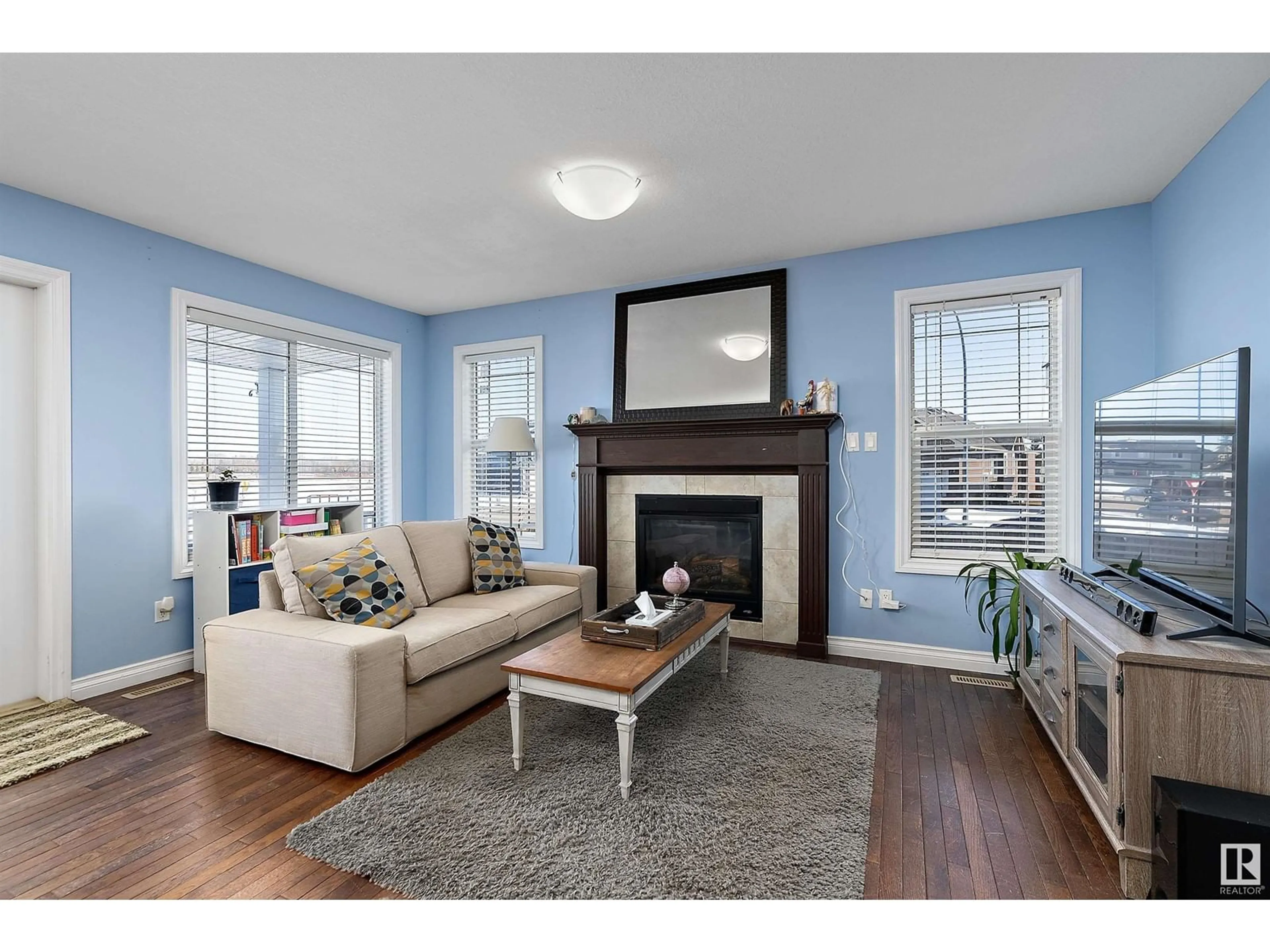 Living room with furniture, wood/laminate floor for 6901 50 AVE, Camrose Alberta T4V5C6