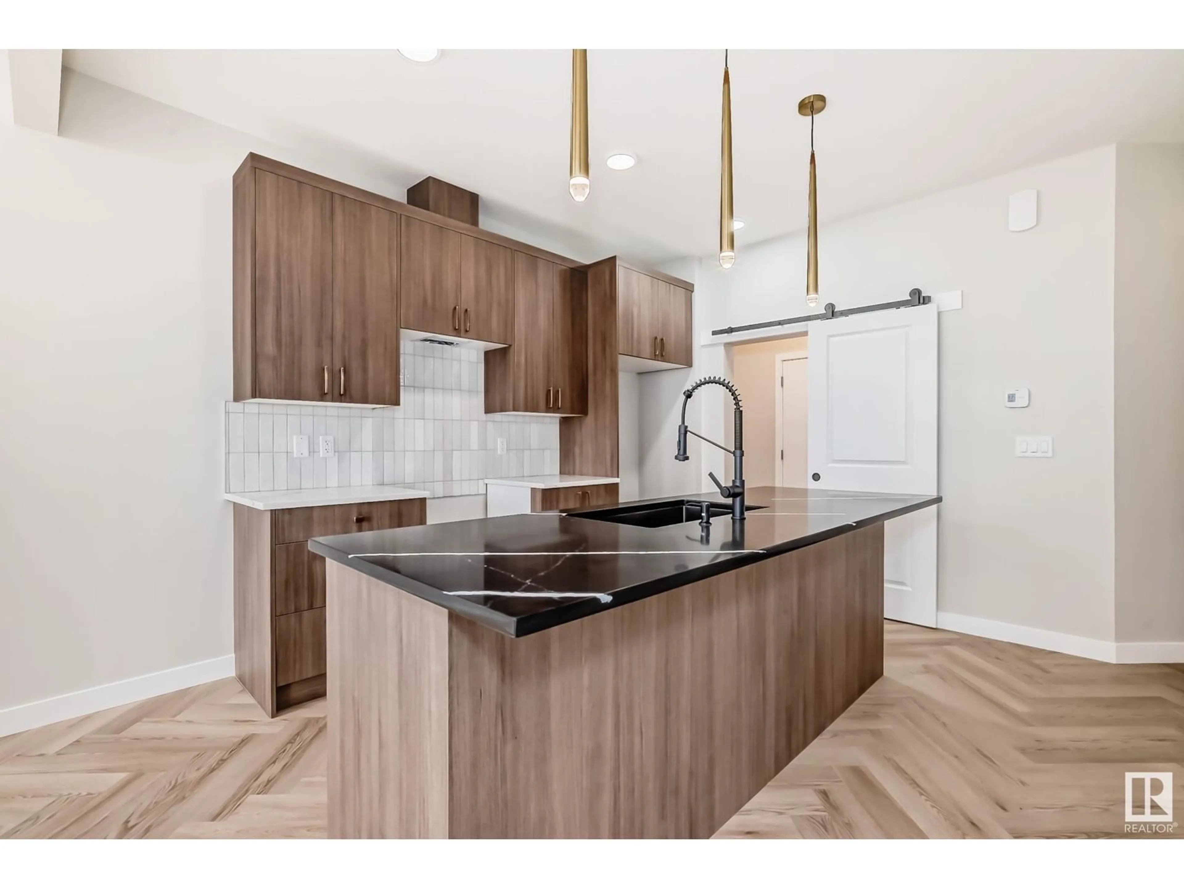 Open concept kitchen, wood/laminate floor for SW - 8209 KIRIAK LO, Edmonton Alberta T6W5S2