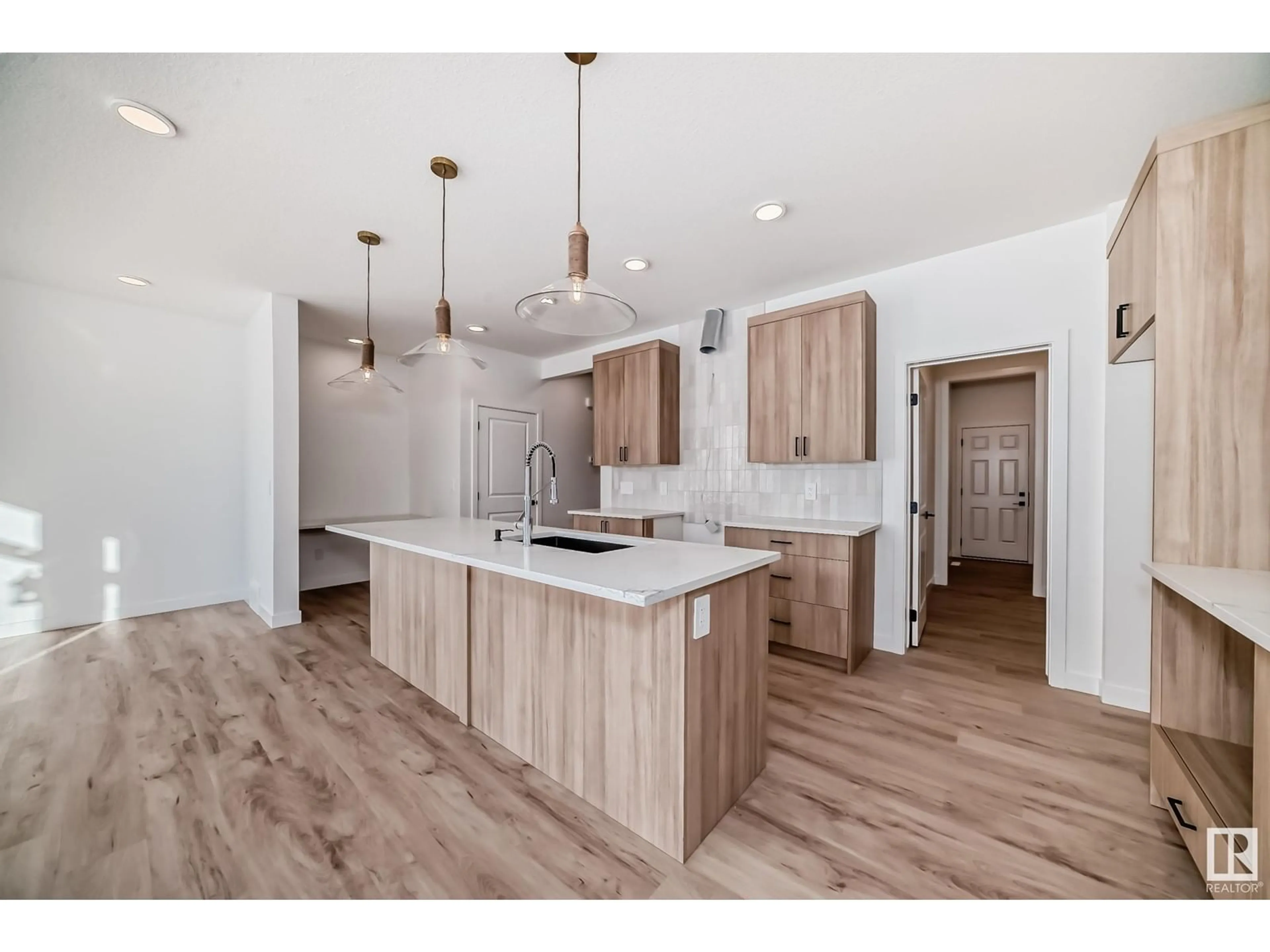 Open concept kitchen, wood/laminate floor for SW - 8215 KIRIAK LO, Edmonton Alberta T6W5S2
