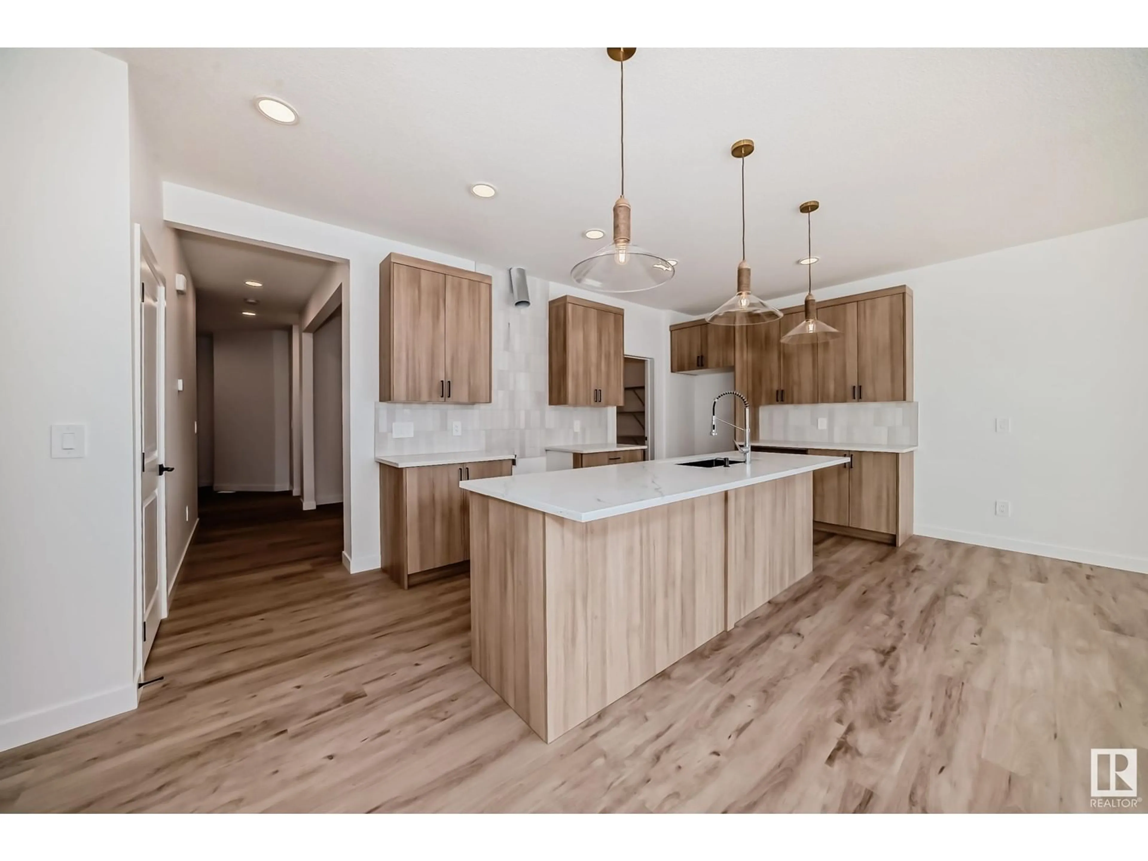 Open concept kitchen, wood/laminate floor for SW - 8215 KIRIAK LO, Edmonton Alberta T6W5S2