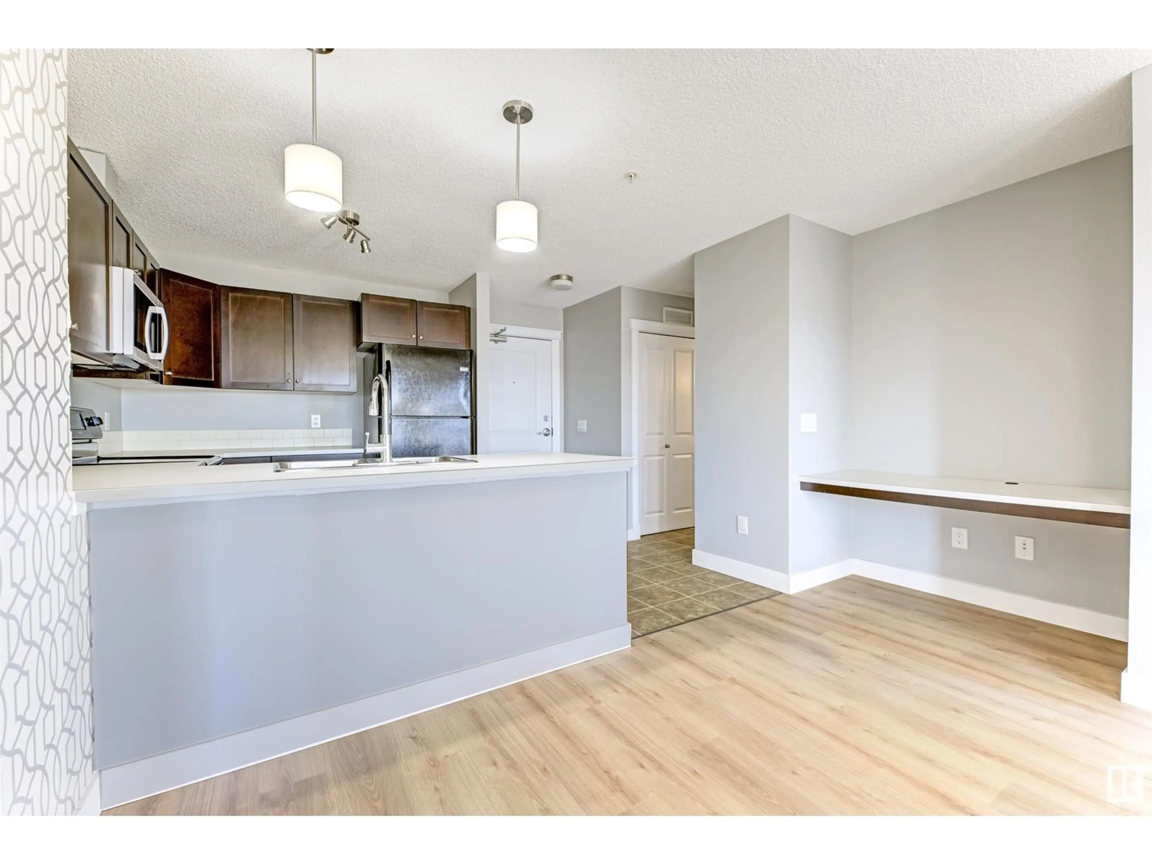 Open concept kitchen, wood/laminate floor for #205 - 3715 WHITELAW LN, Edmonton Alberta T6W2C3