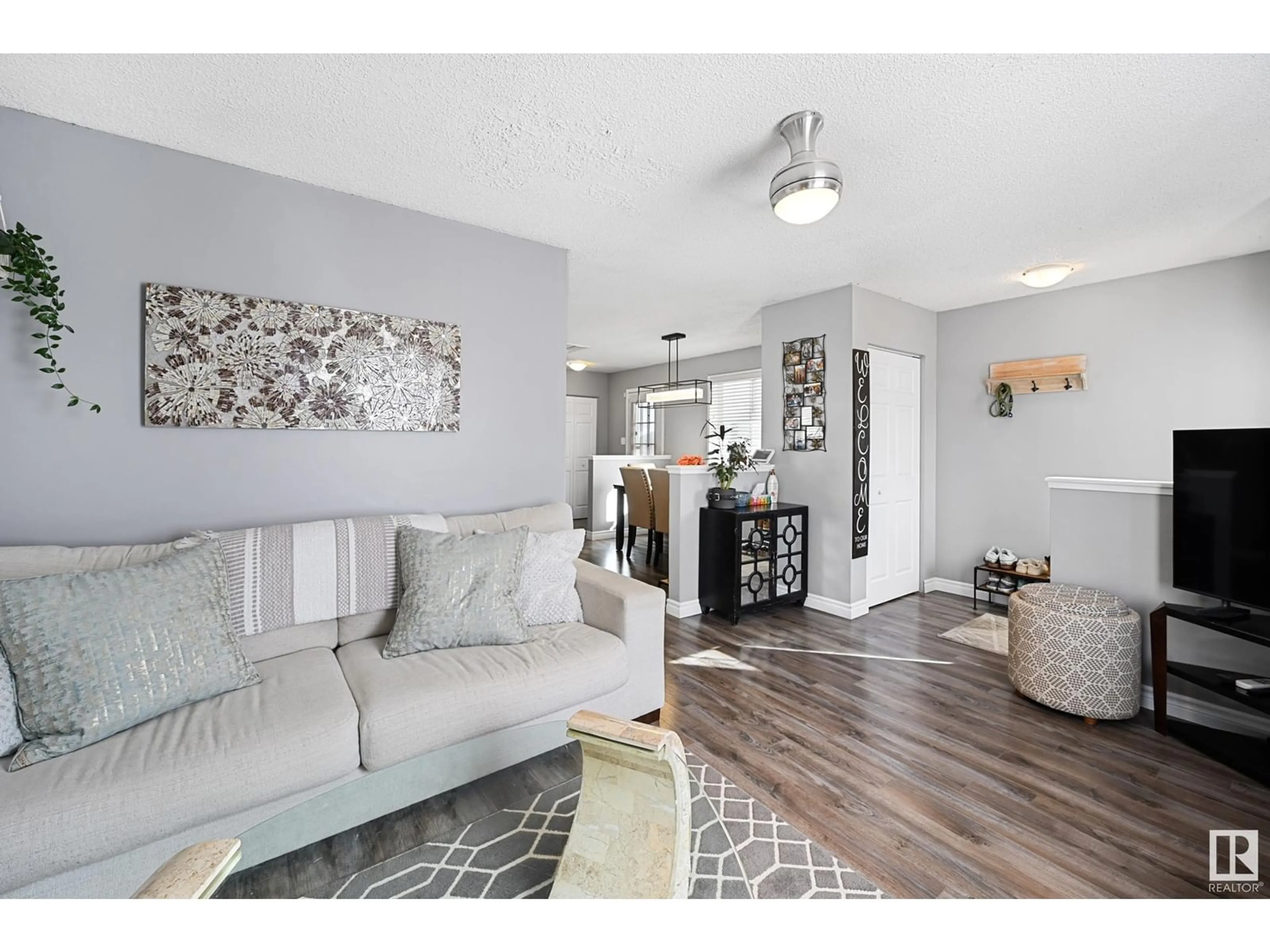 Living room with furniture, wood/laminate floor for 16225 57 ST NW, Edmonton Alberta T5Y2V2