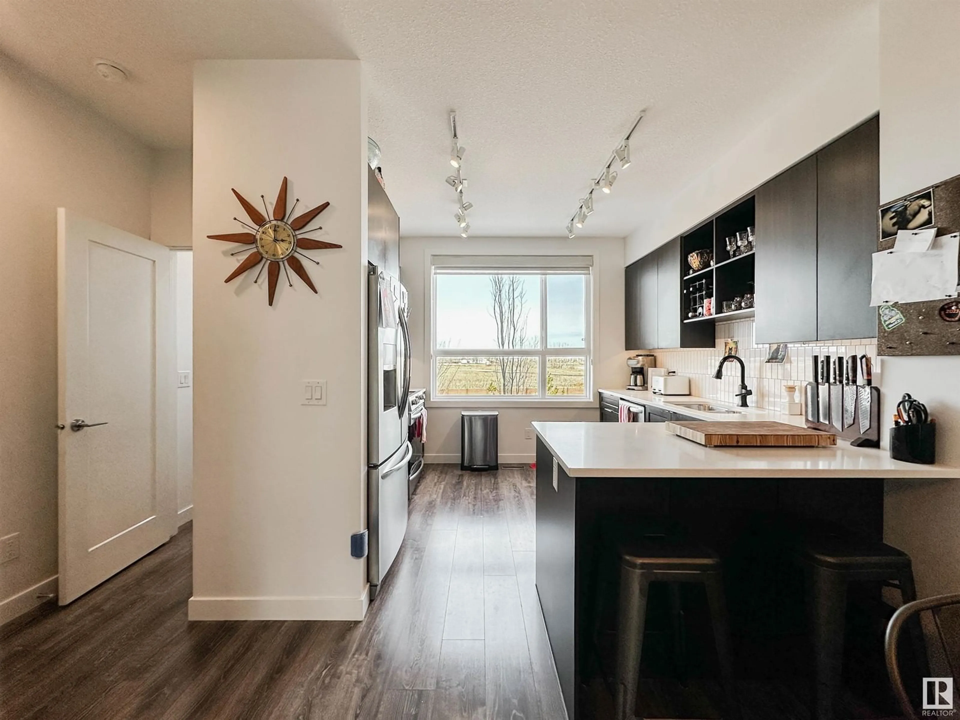 Open concept kitchen, wood/laminate floor for #11 - 100 JENSEN LAKES BV, St. Albert Alberta T8N7T9