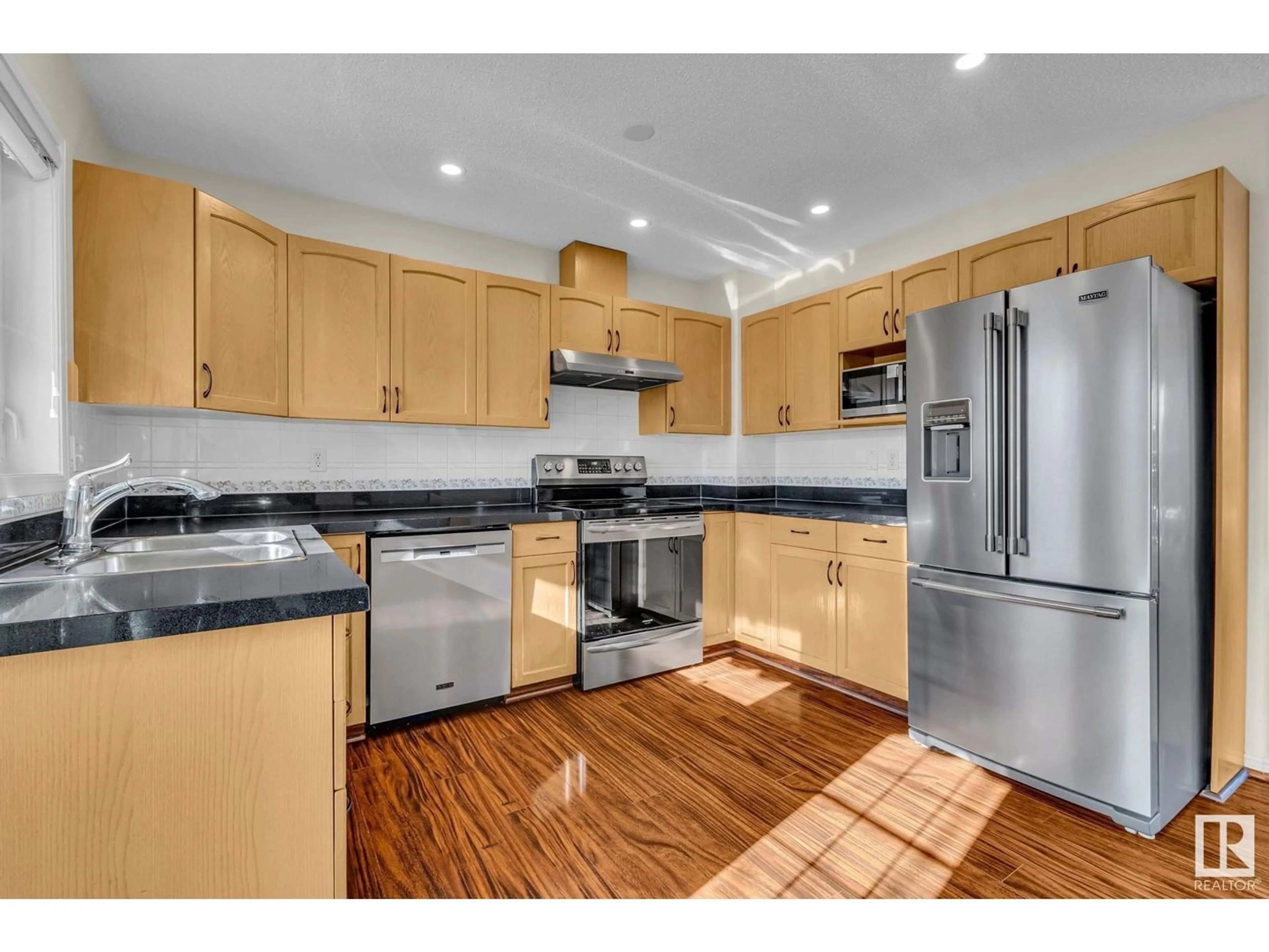Open concept kitchen, wood/laminate floor for 64 - 23 BLACKBURN DR, Edmonton Alberta T6W1C1