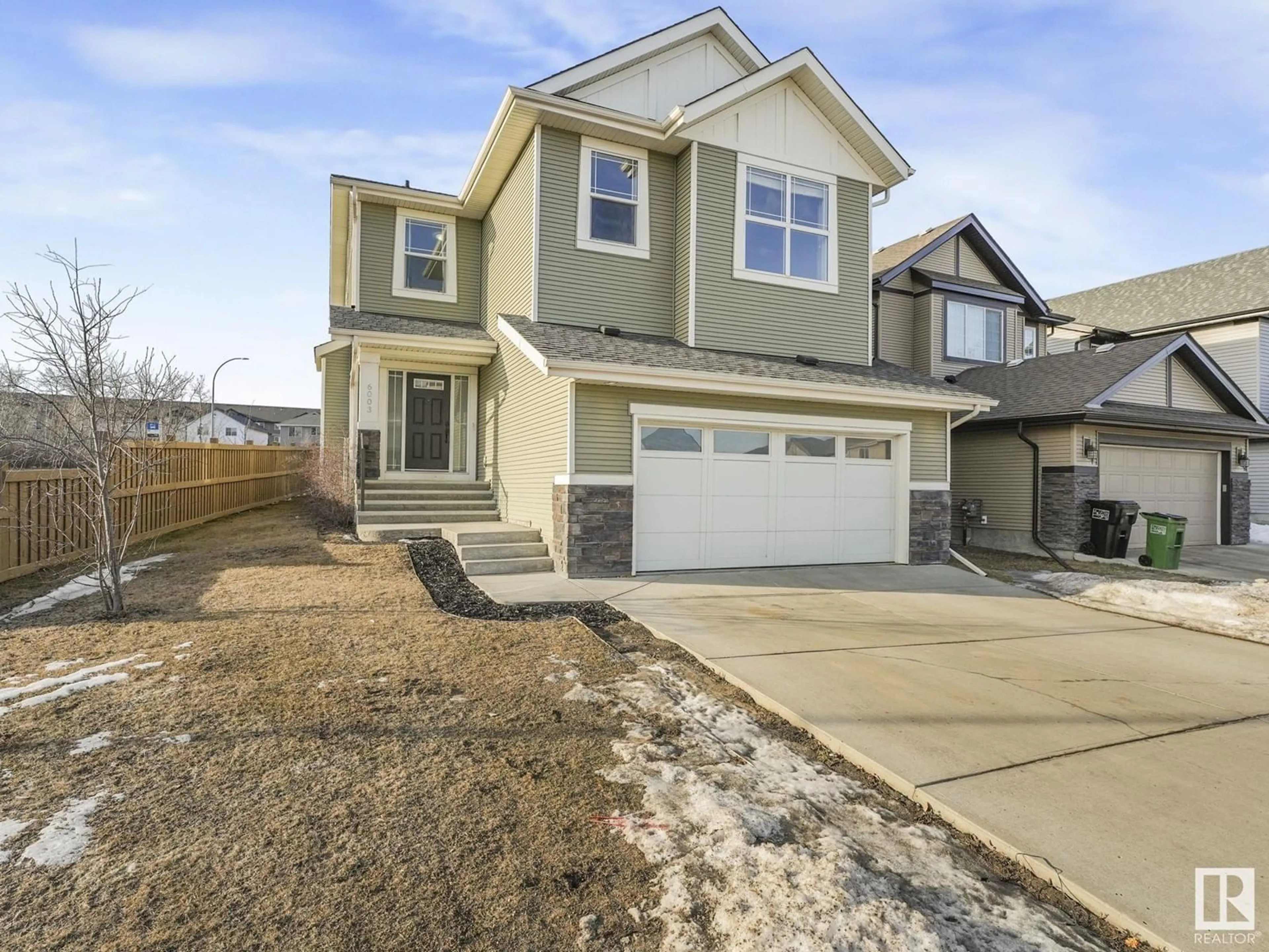 Home with vinyl exterior material, street for 6003 175 AV NW, Edmonton Alberta T5Y0K8