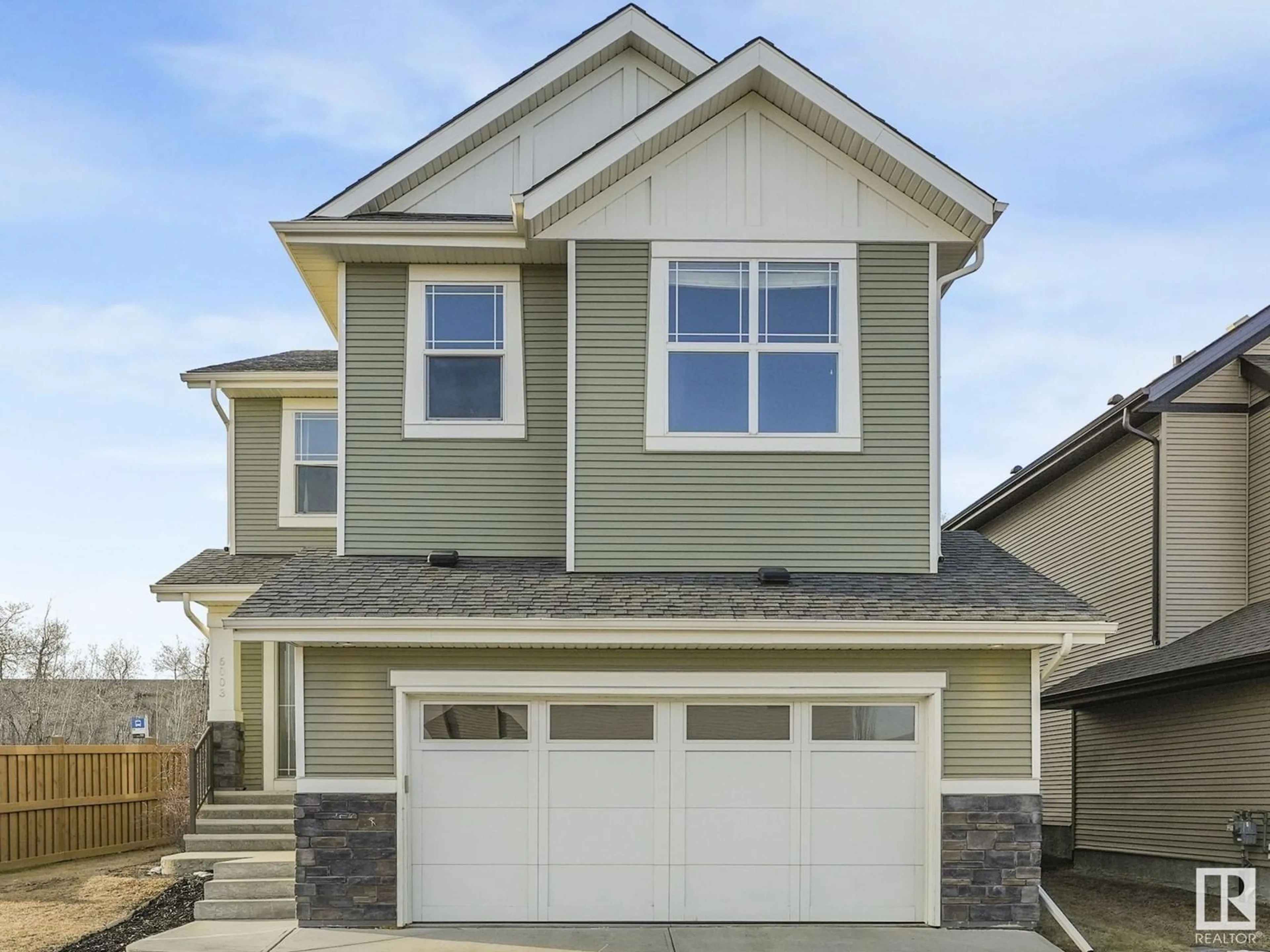 Home with vinyl exterior material, street for 6003 175 AV NW, Edmonton Alberta T5Y0K8