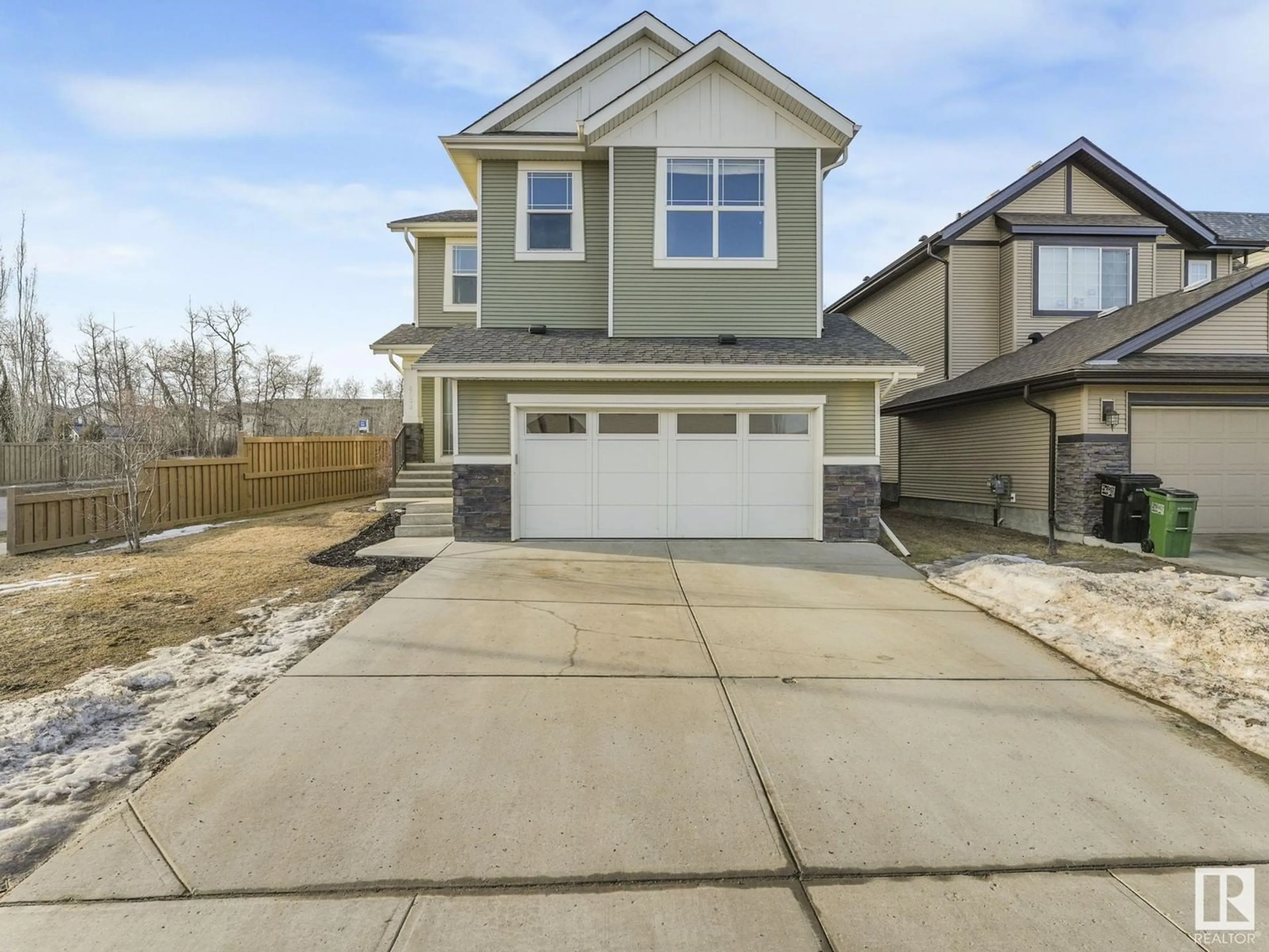 Home with vinyl exterior material, street for 6003 175 AV NW, Edmonton Alberta T5Y0K8