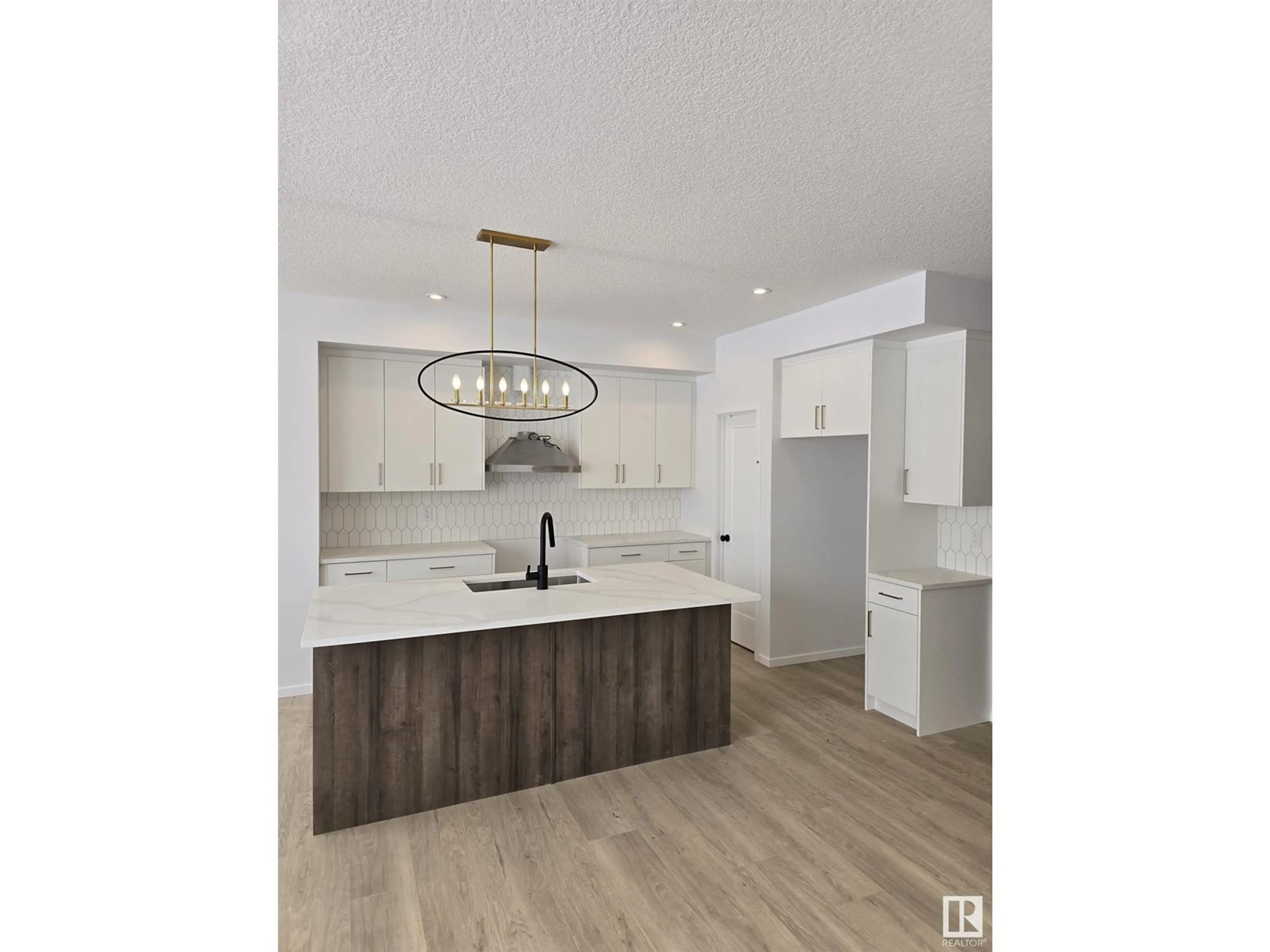 Open concept kitchen, wood/laminate floor for 7718 174A AV, Edmonton Alberta T5Z0W5