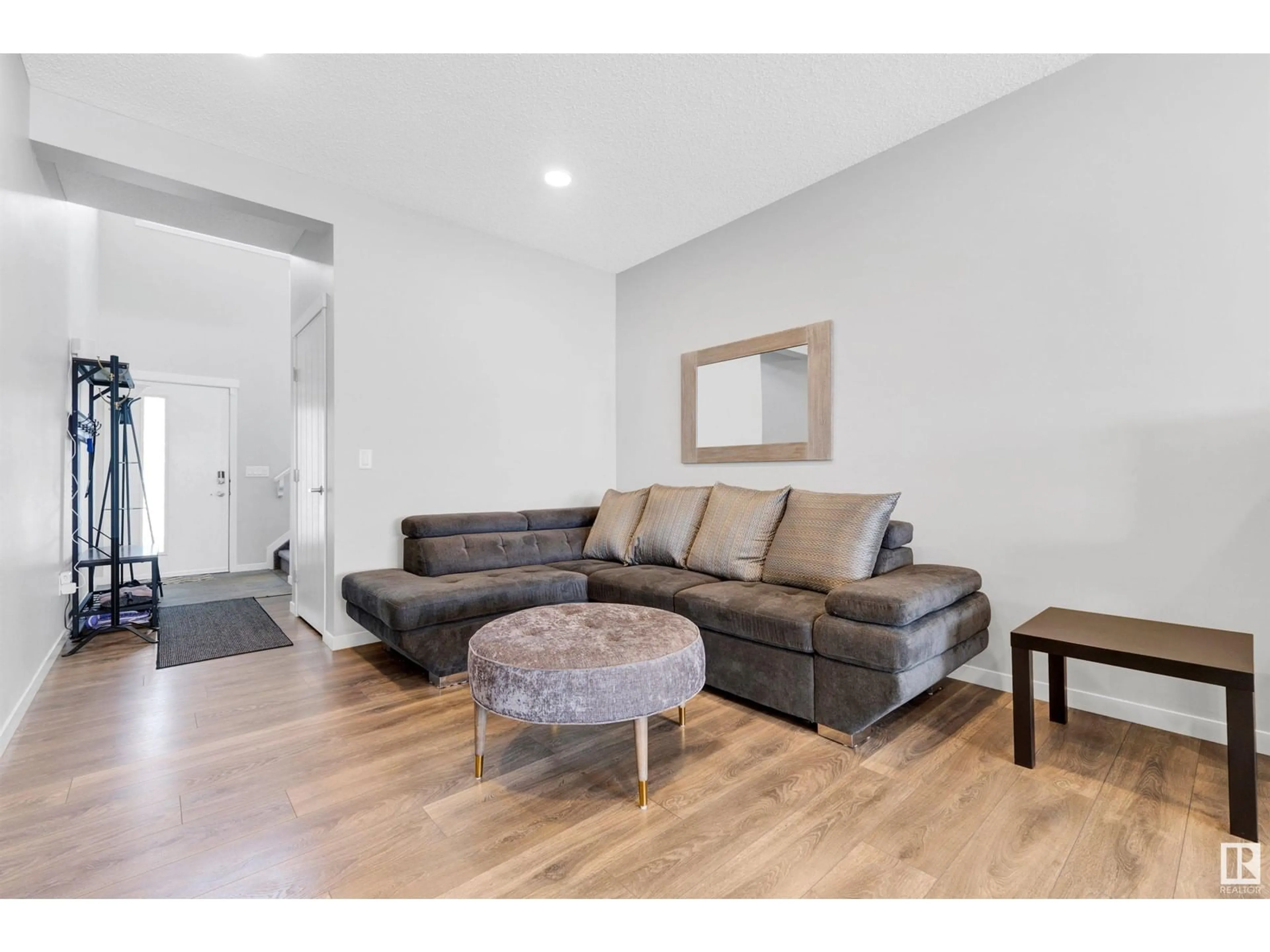 Living room with furniture, wood/laminate floor for 19627 26 AV, Edmonton Alberta T6M0X4