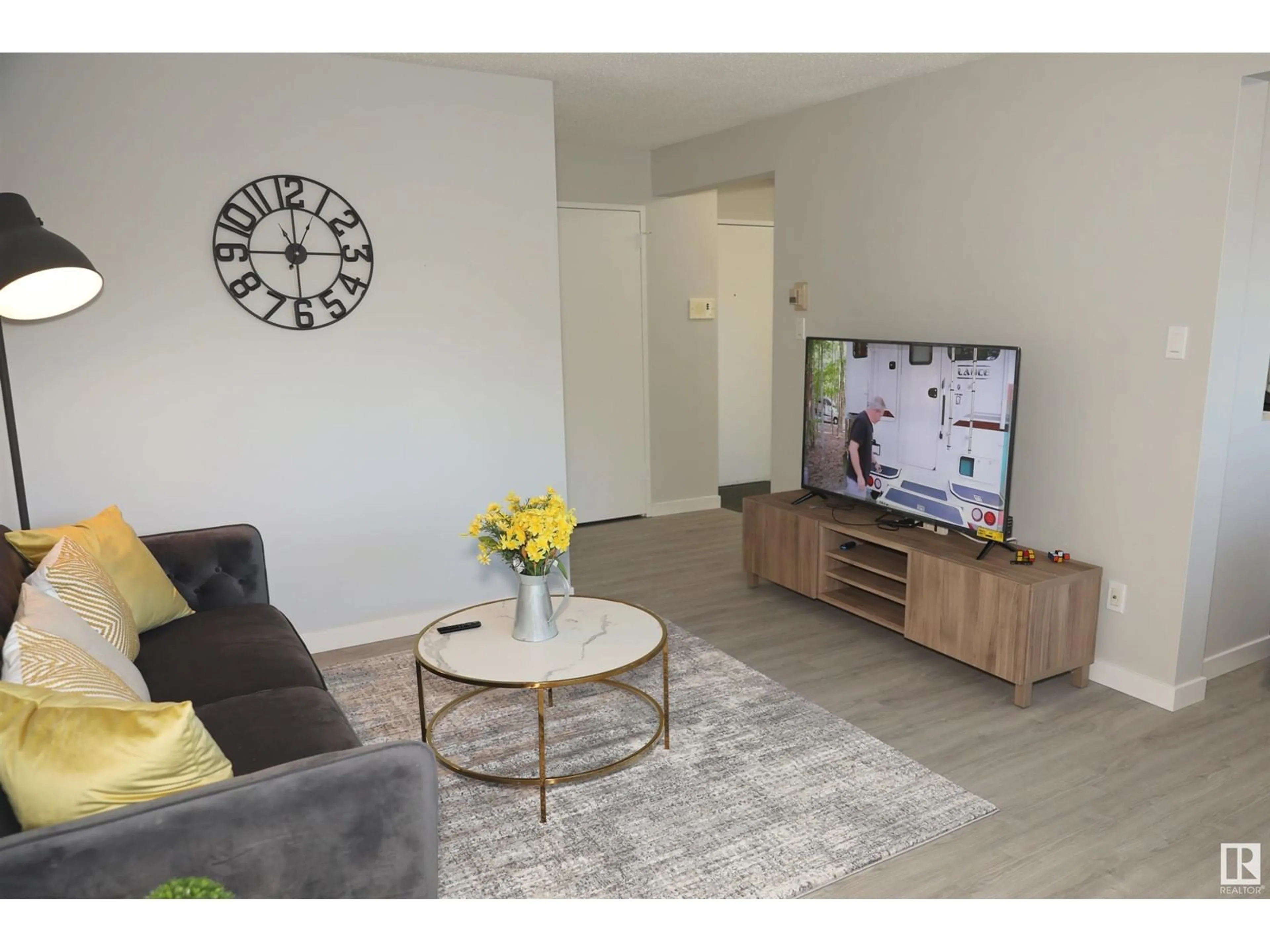 Living room with furniture, wood/laminate floor for 106 - 11465 41 AV, Edmonton Alberta T6J0T9