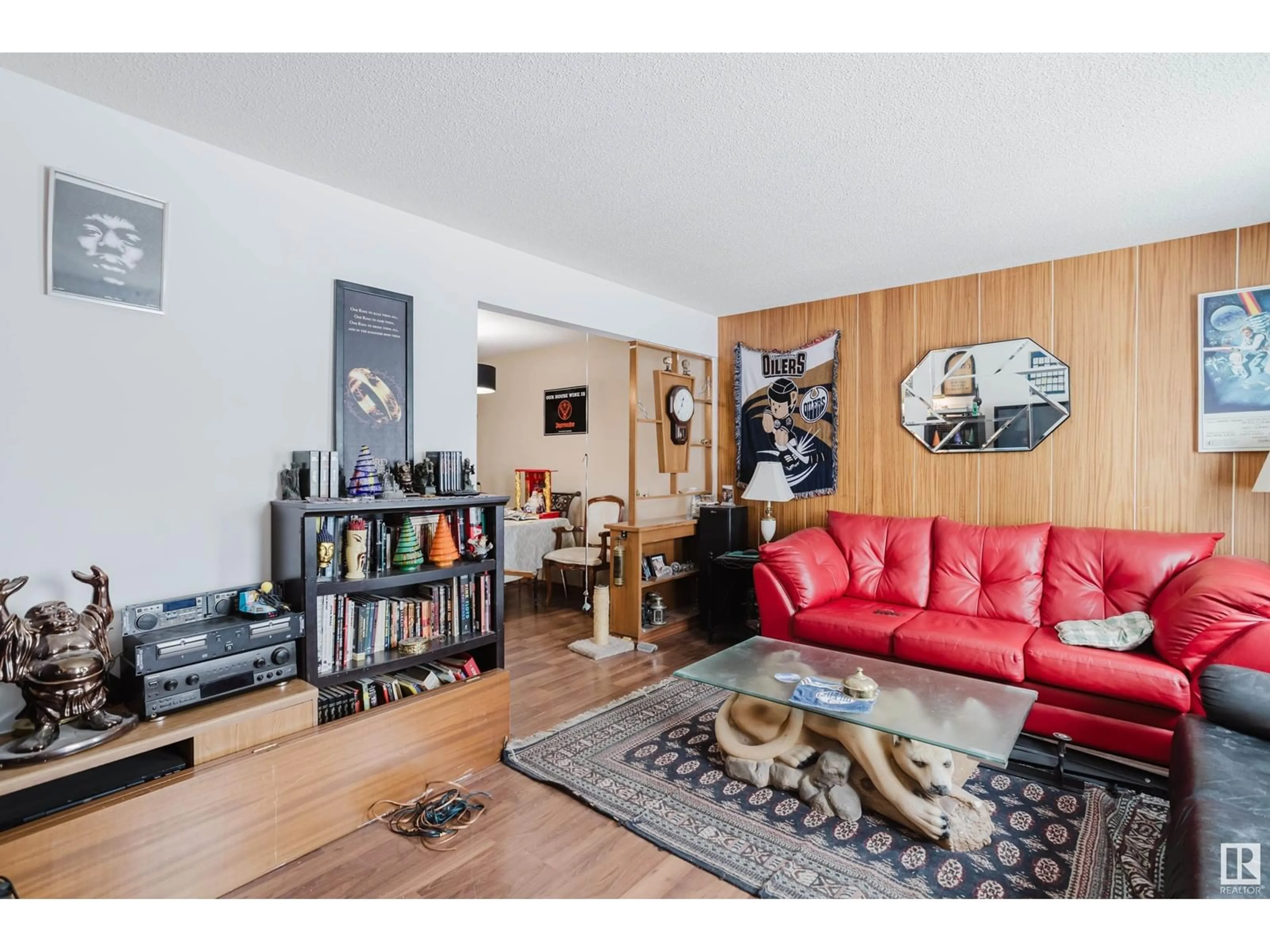Living room with furniture, wood/laminate floor for NW - 7311 7313 79 AV, Edmonton Alberta T6B0C4