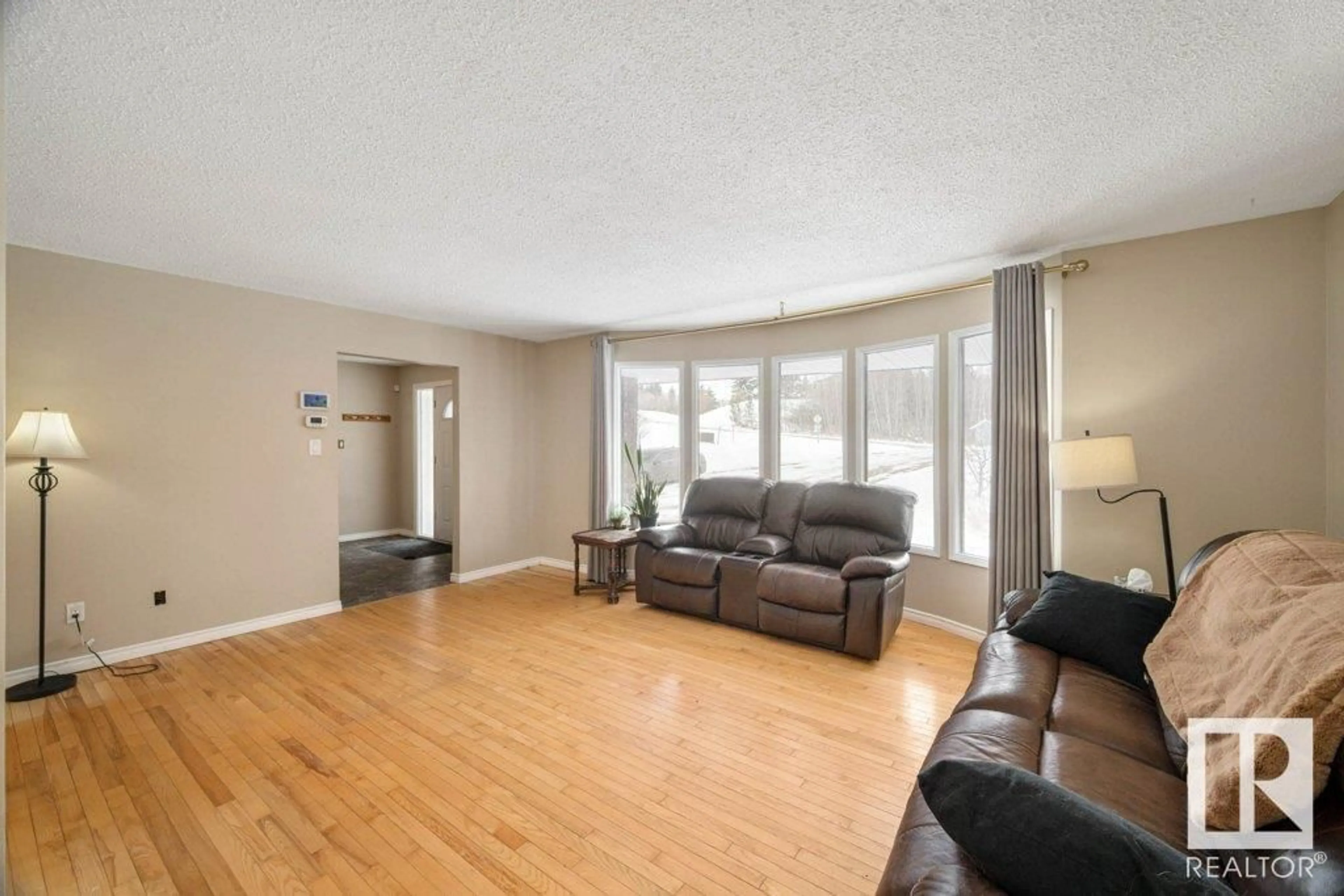 Living room with furniture, wood/laminate floor for 70 56019 RANGE ROAD 230, Rural Sturgeon County Alberta T0A1N2