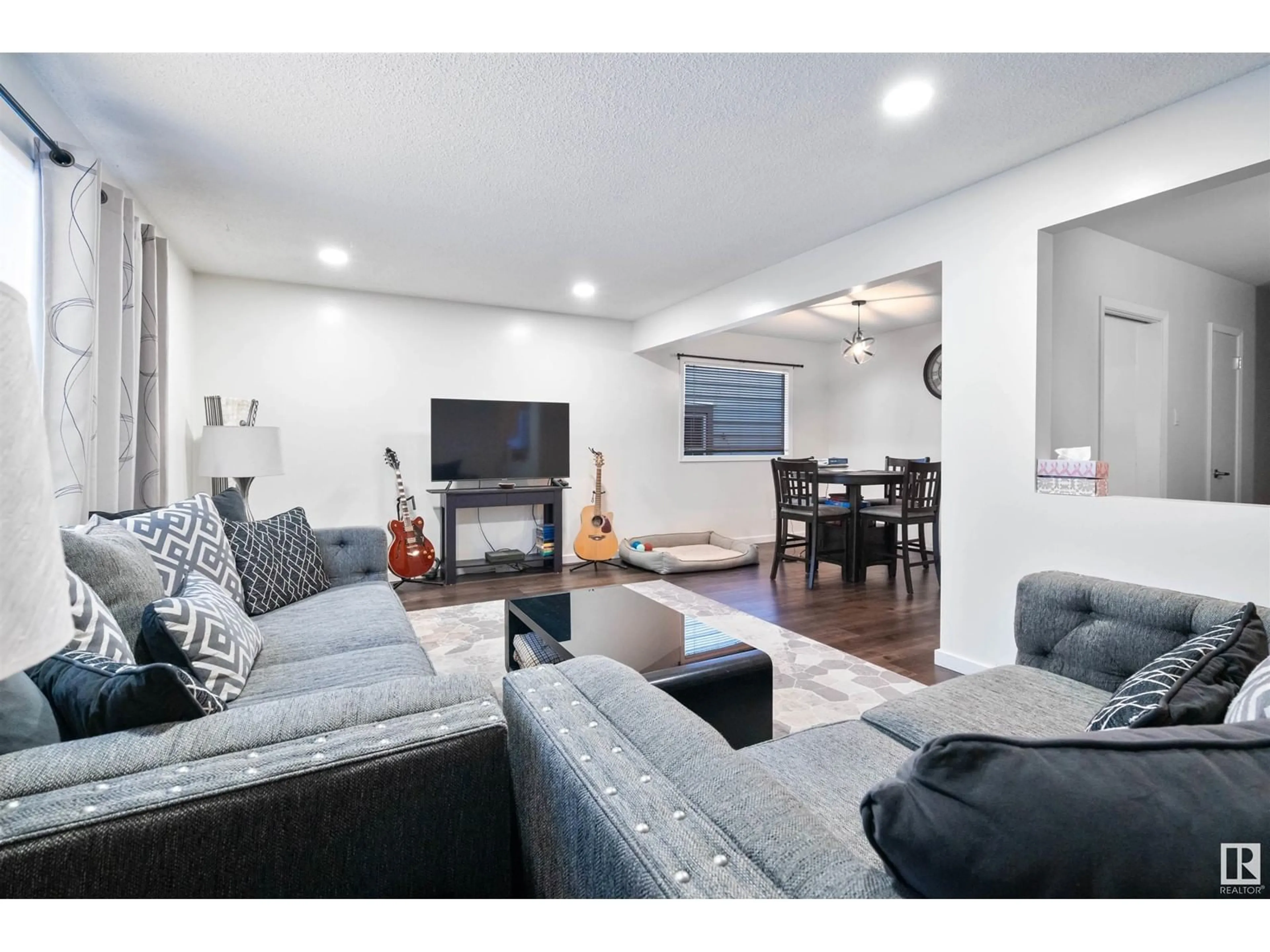Living room with furniture, wood/laminate floor for NW - 11615 88 ST, Edmonton Alberta T5B3R5