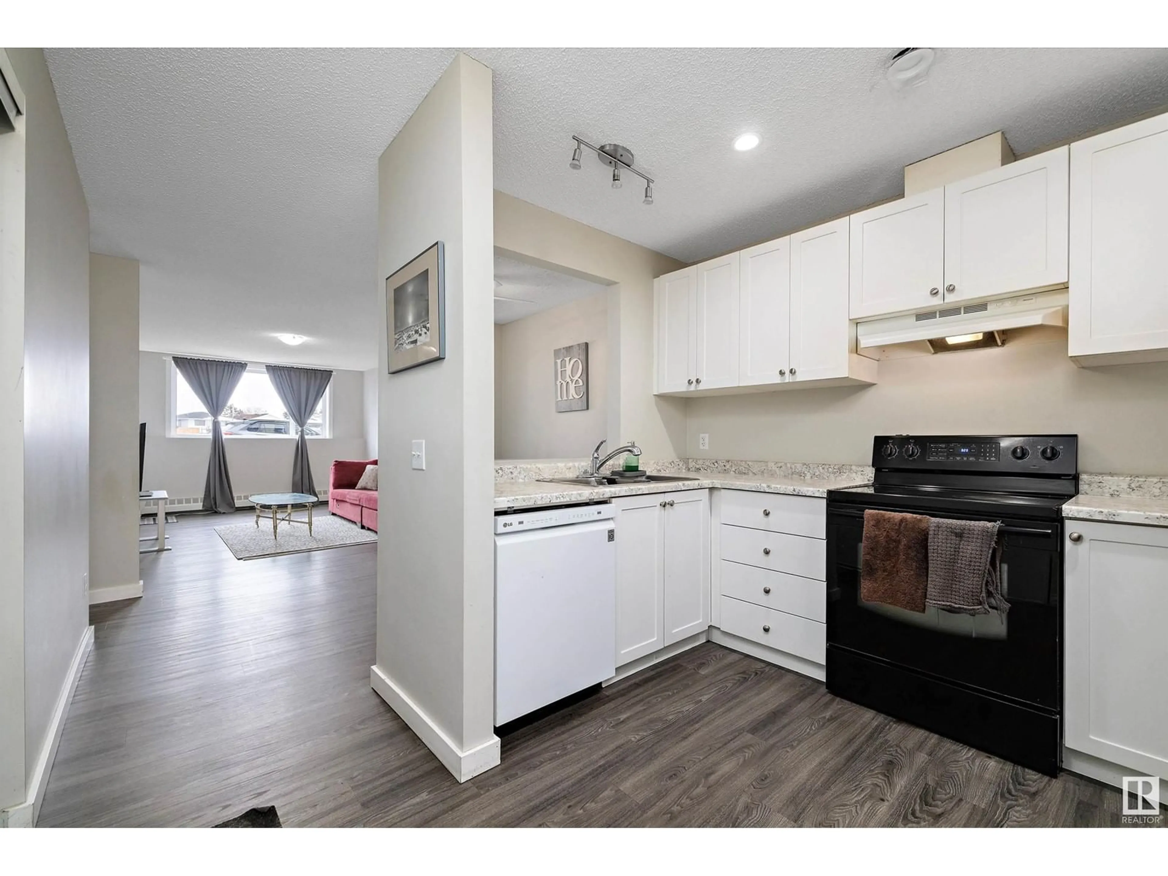 Open concept kitchen, wood/laminate floor for #101 - 14808 26 ST, Edmonton Alberta T5Y2G4
